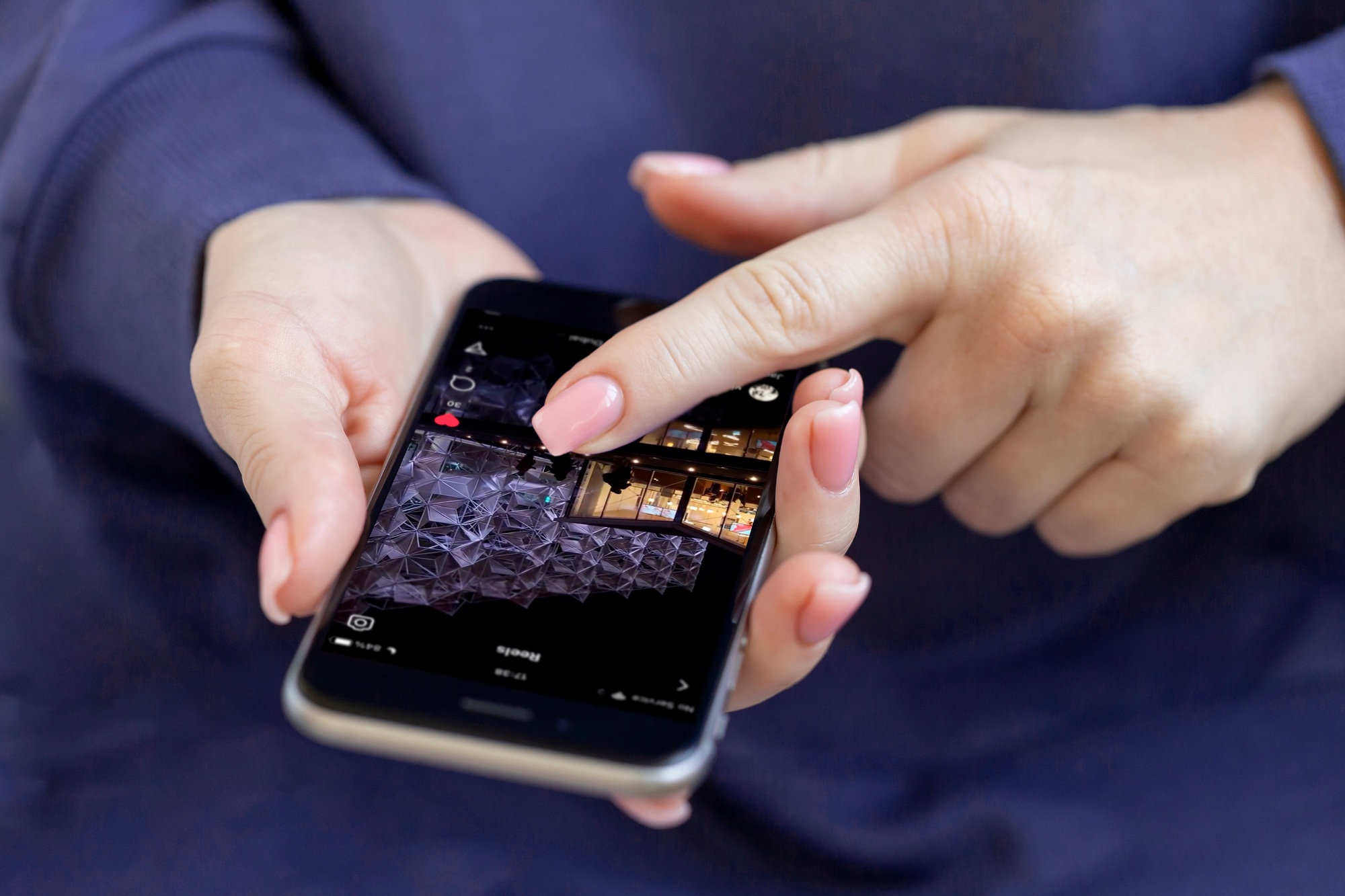 Woman checking daily instagram reels, social media is part of our lives. Female hands only in frame.