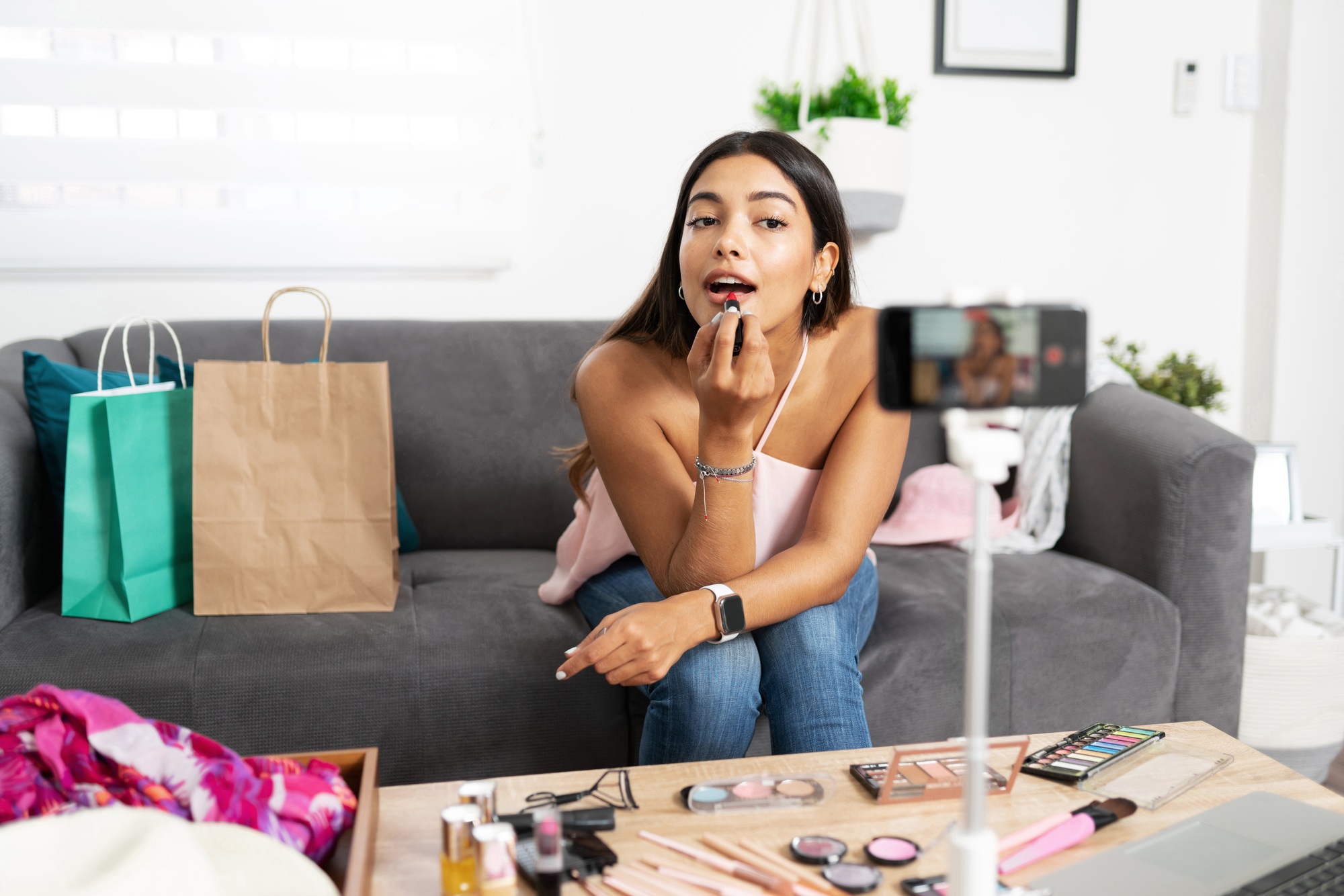 Woman putting makeup on social media