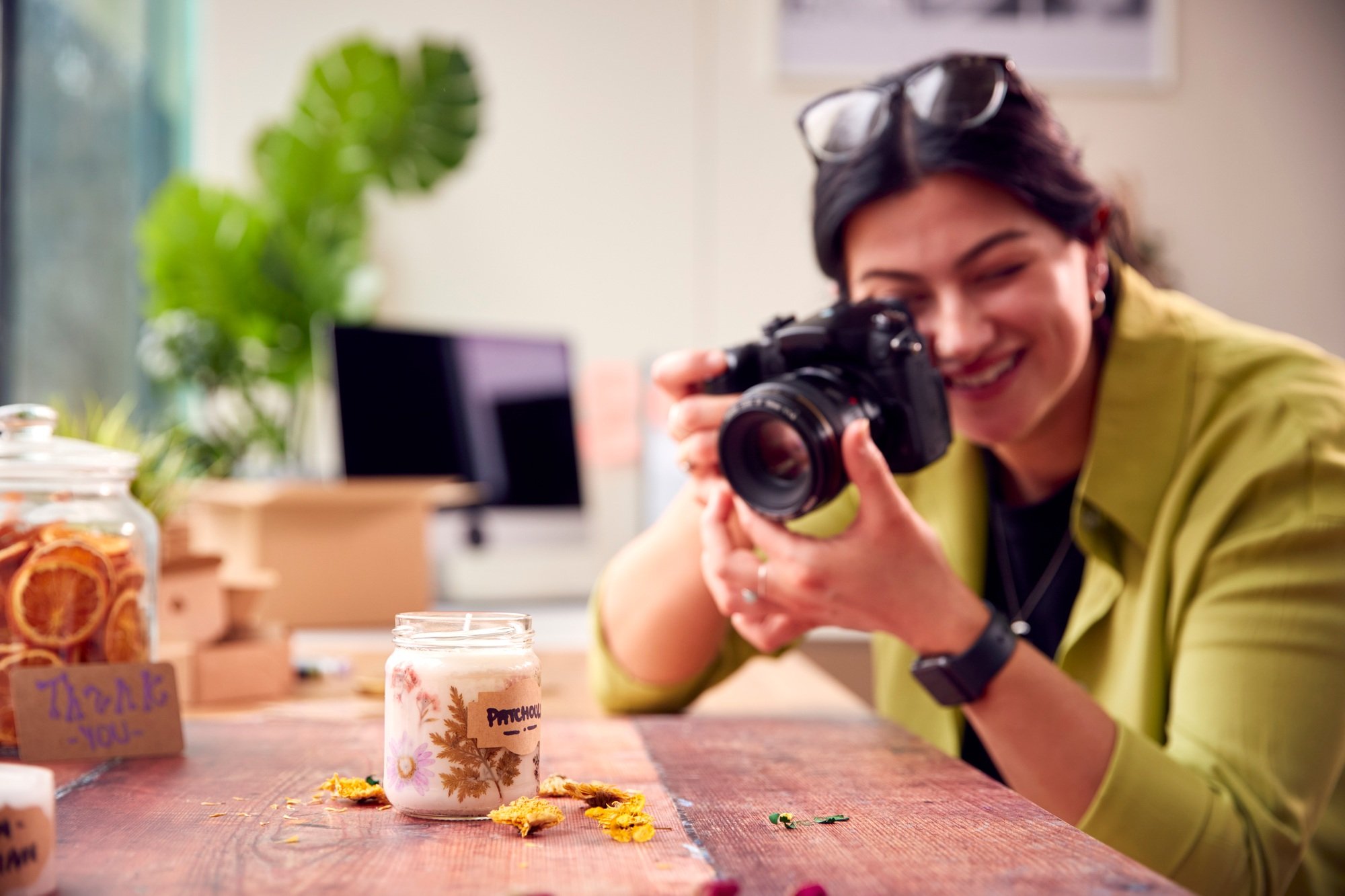 Woman Running Online Business Making Boutique Candles Taking Photos For Online Marketing