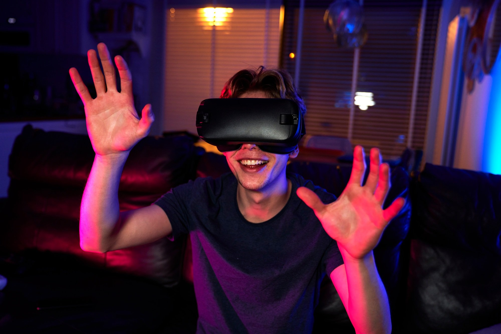 Young caucasian man having fun while using VR glasses