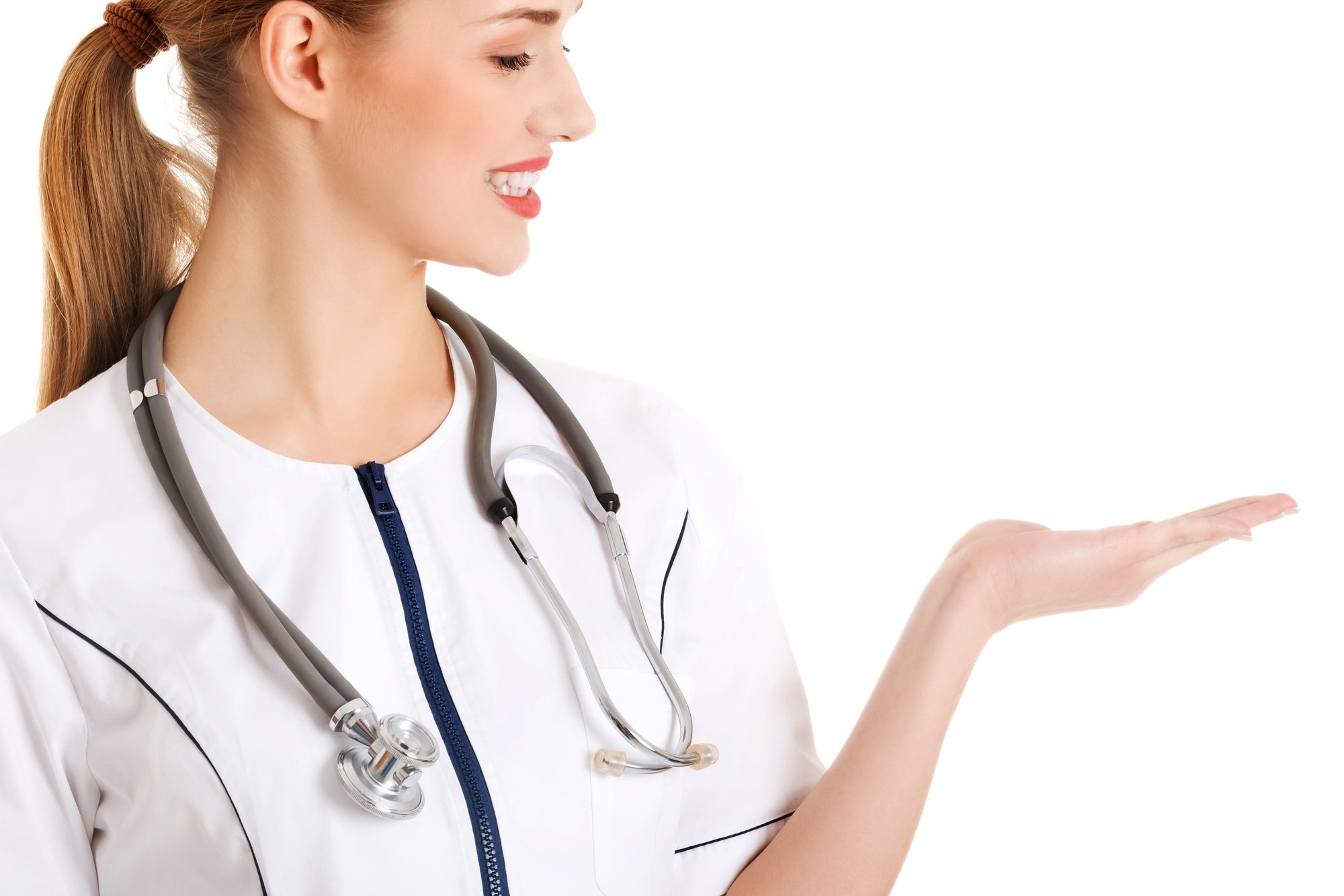 Young female doctor showing a blank space for text or logo isolated on white background
