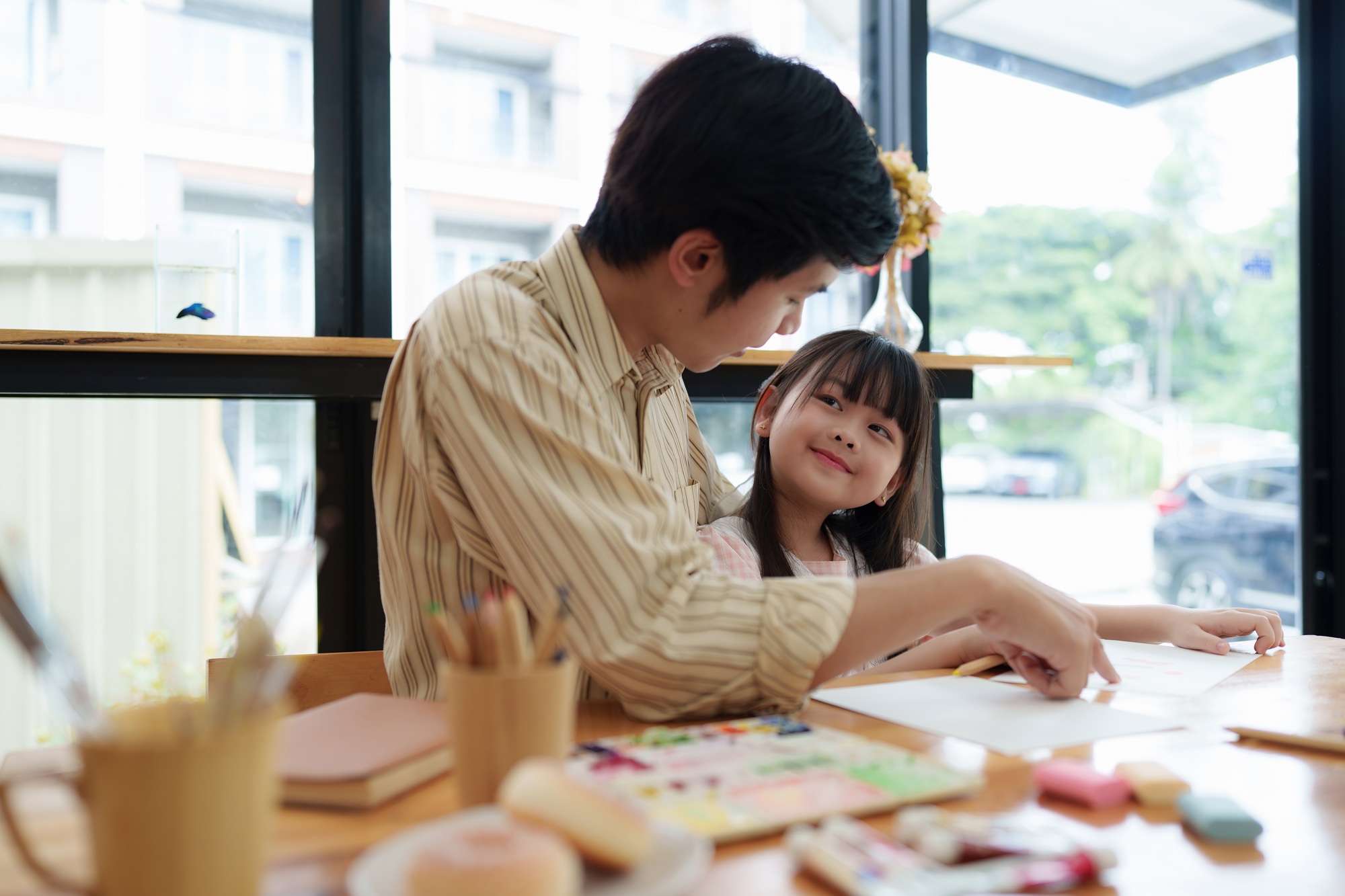 A happy kid and this father painting at home. Handmade skills training