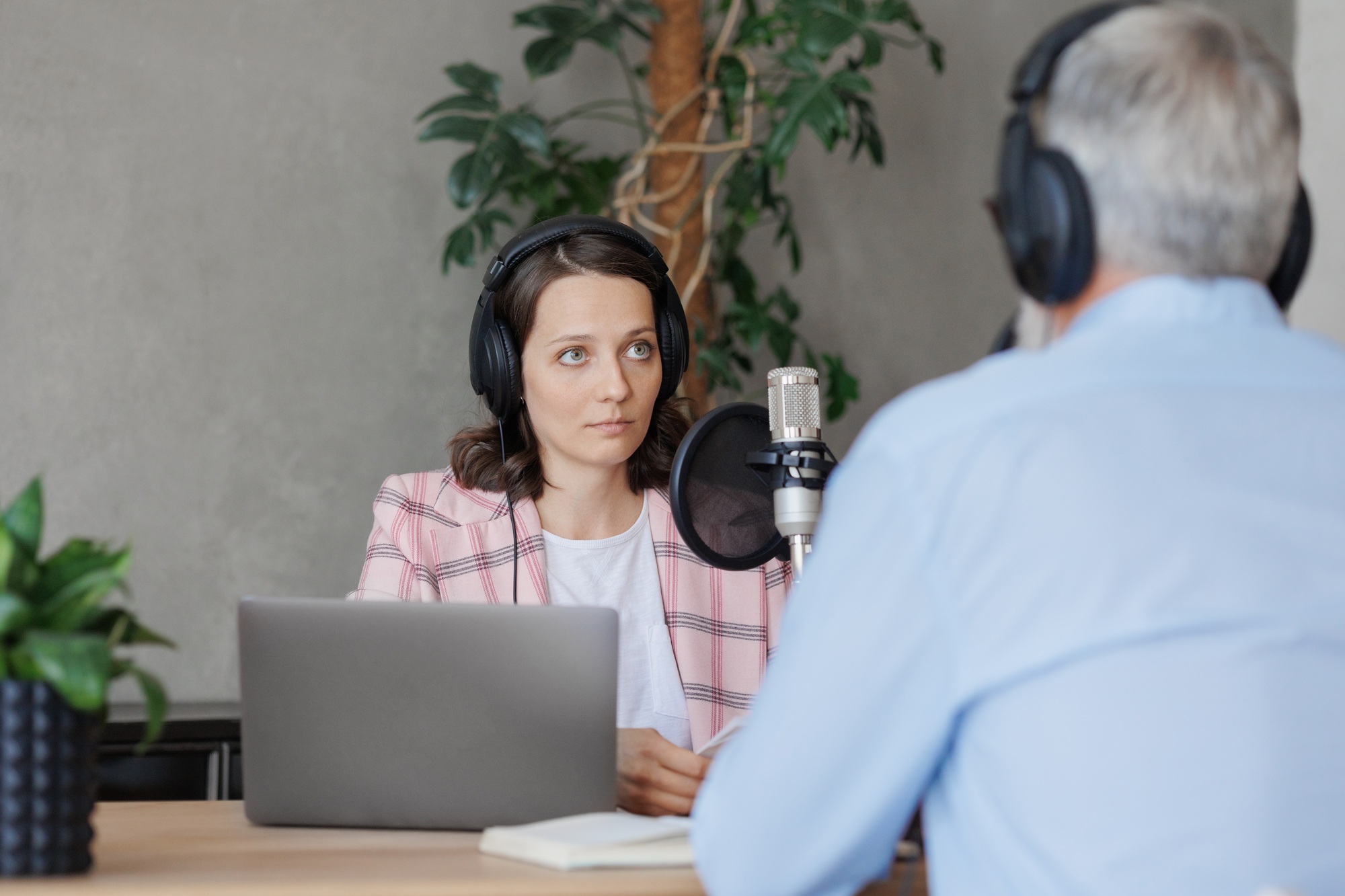 a man and a woman in a radio studio discuss current issues or record a voice for an advertisement