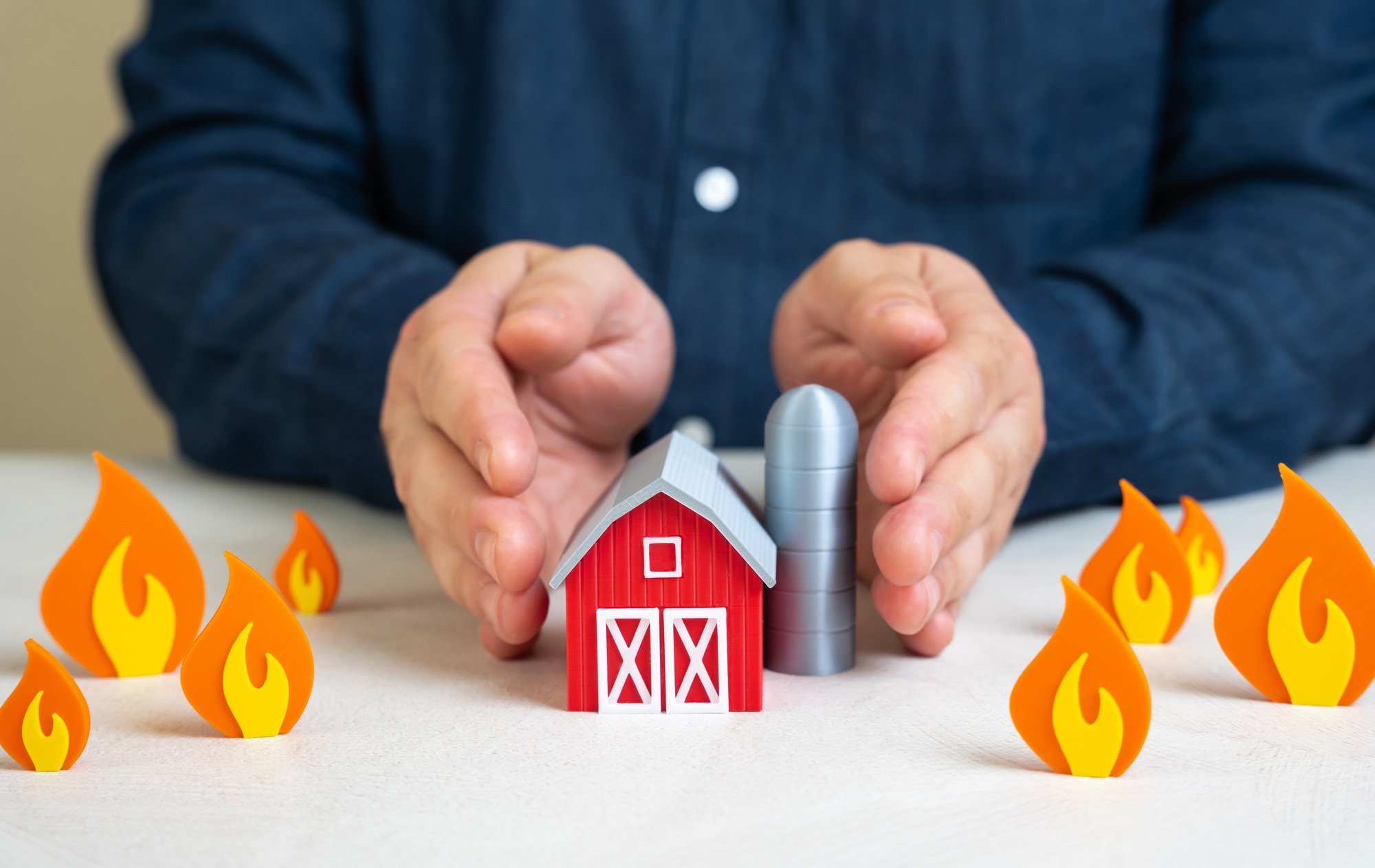 A man protects a farm from fire. Safety in difficult climate conditions. Droughts and fires.