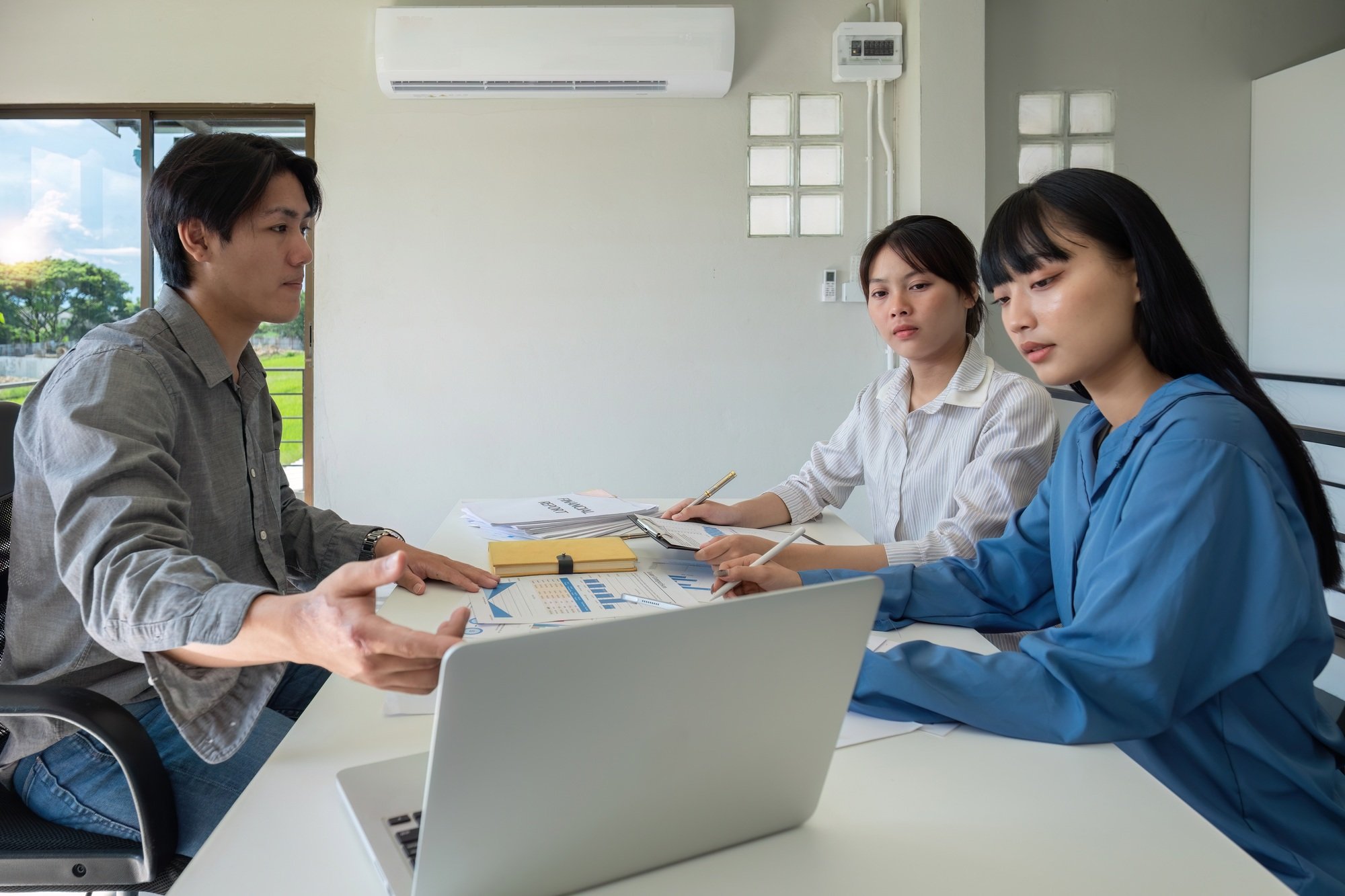 A professional business team is meeting to discuss company management practices in a modern