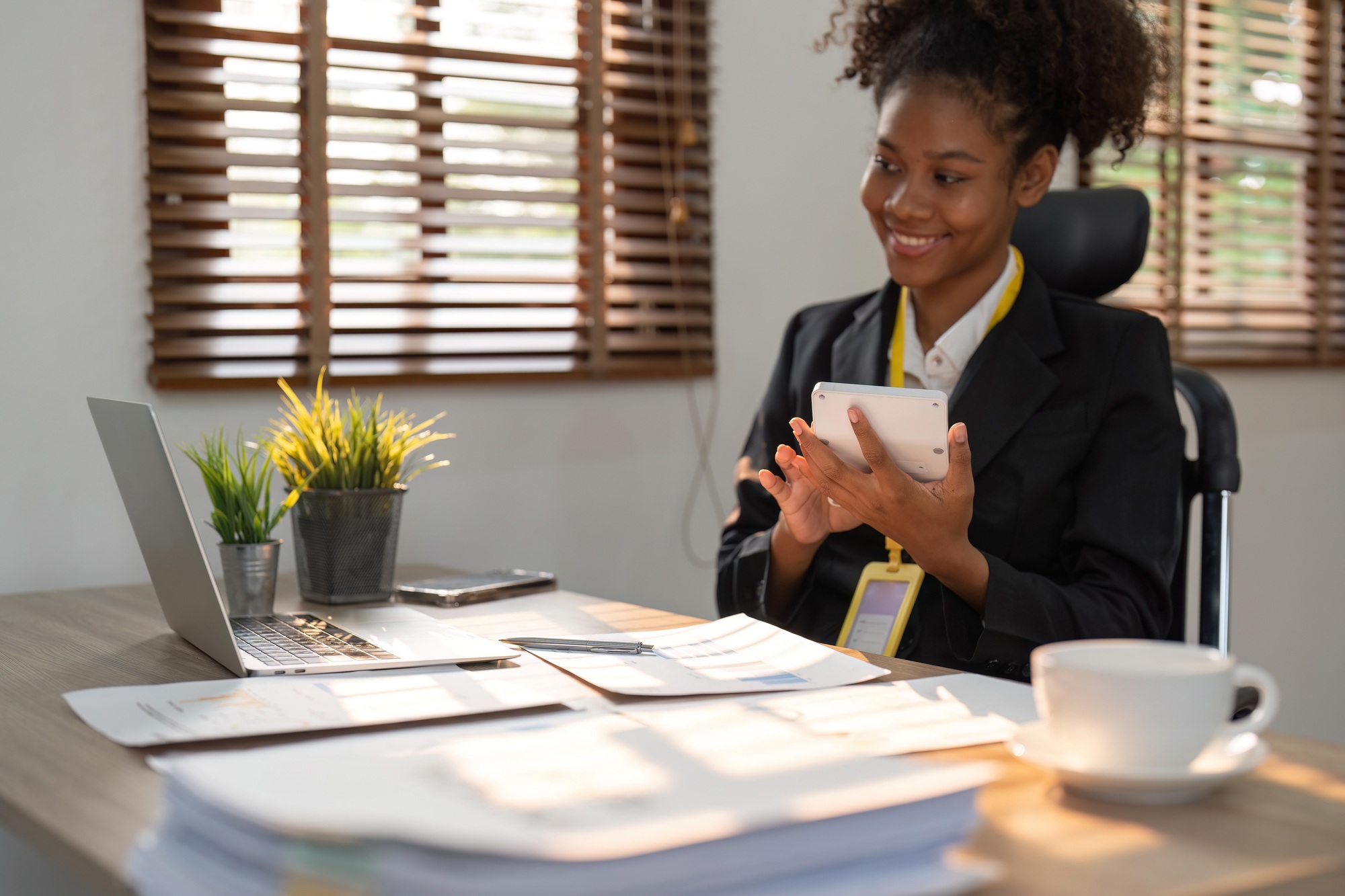 Accountant black woman working on laptop and calculator for do document, tax, exchange, accounting