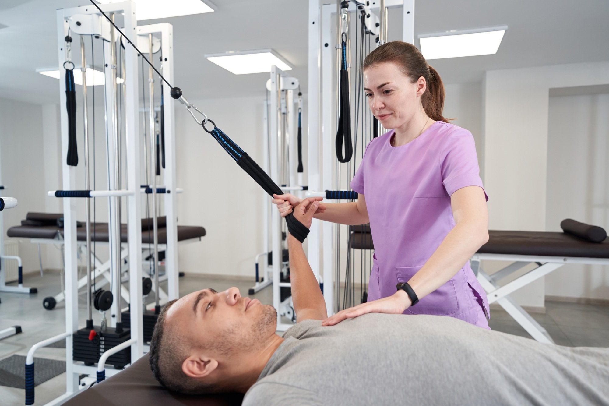 African American man doing physical therapy exercise with instructor