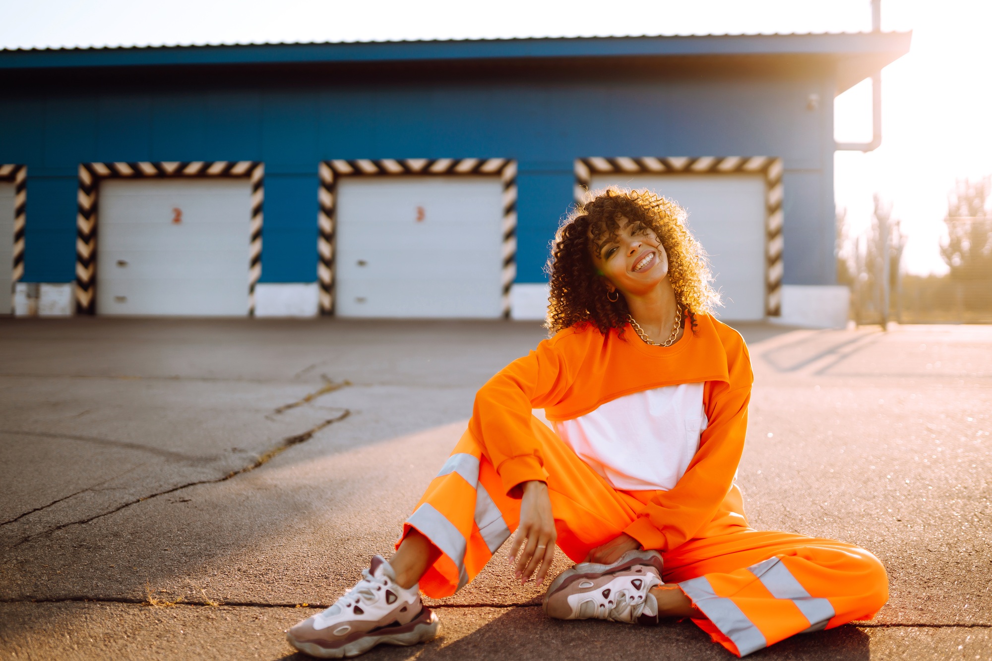 African American woman - dancer dancing in street at sunset. Sport, dancing, urban culture concept.