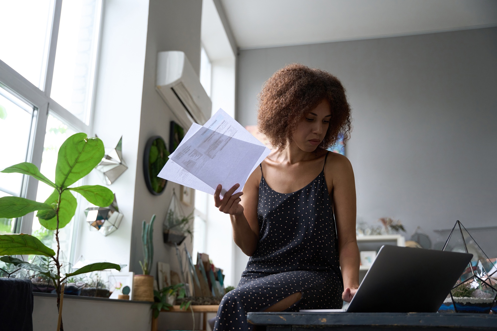 Ambitious young lady sorting out paperwork at home