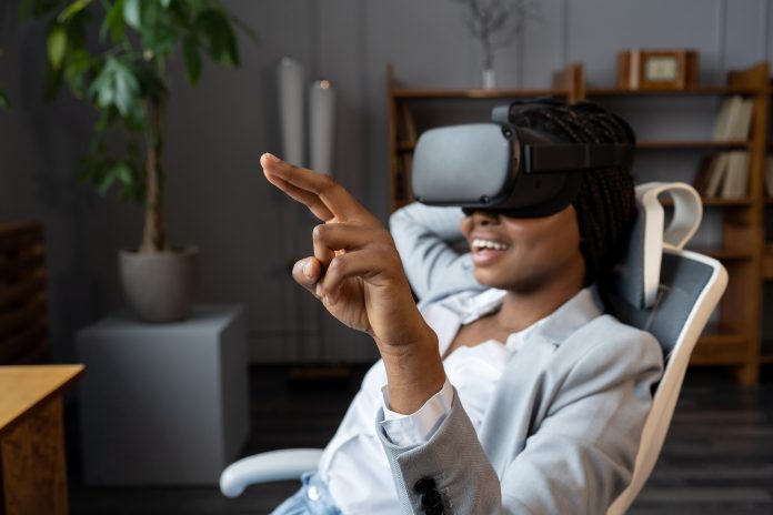 Amused african american businesswoman testing VR software for business at her workplace in office