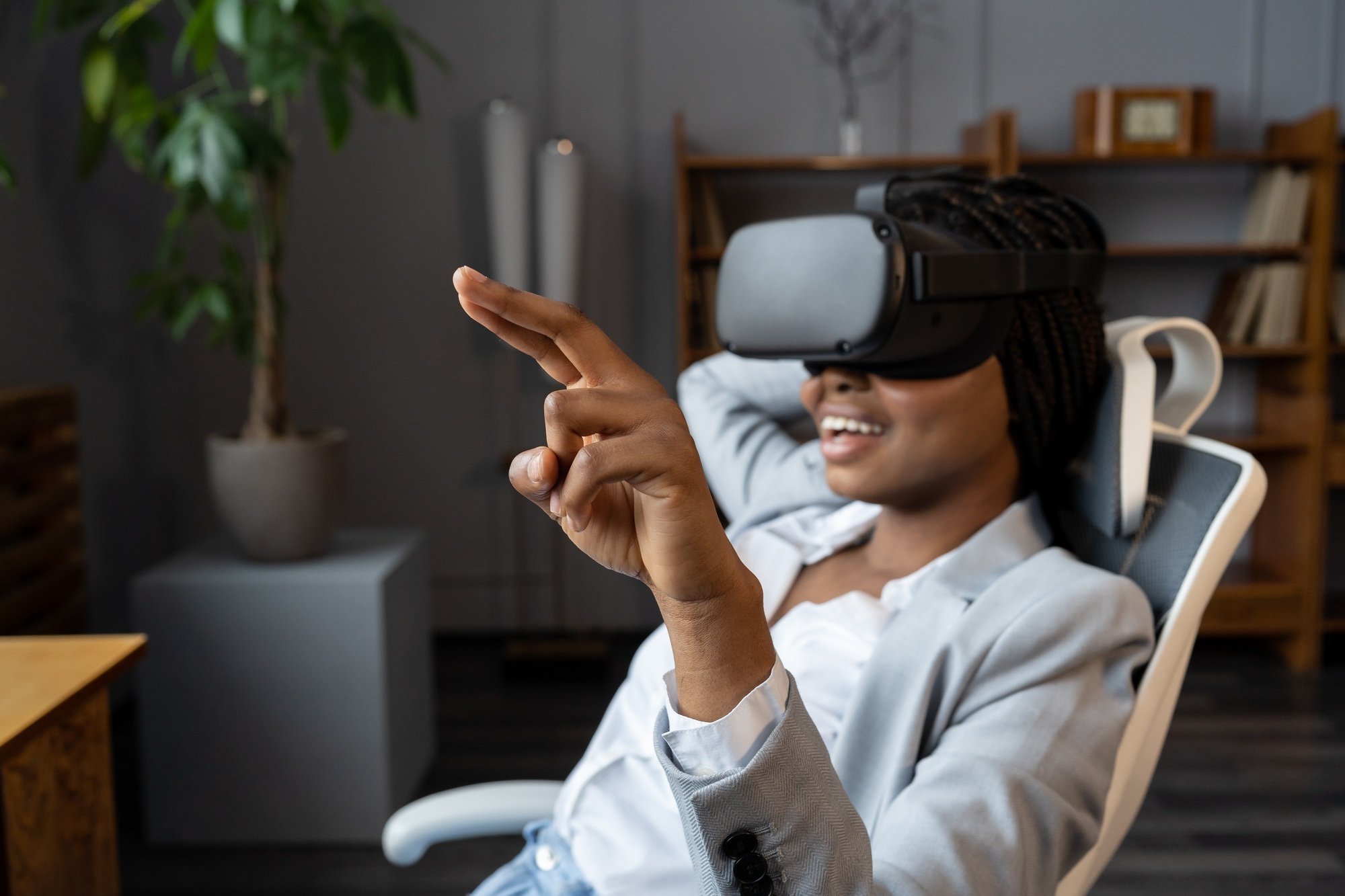 Amused african american businesswoman testing VR software for business at her workplace in office