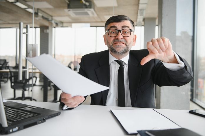 Angry boss behind of office table
