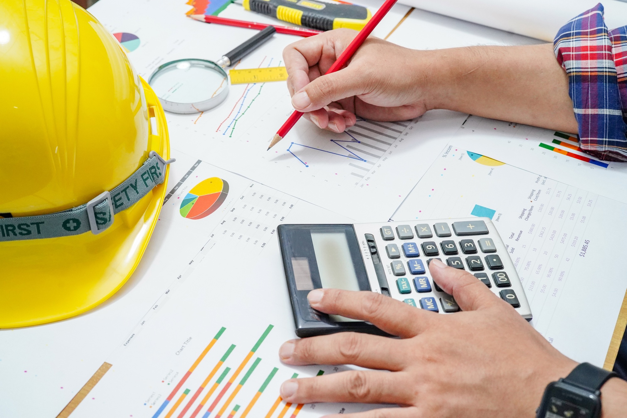 Architect or engineer working project accounting with graph
