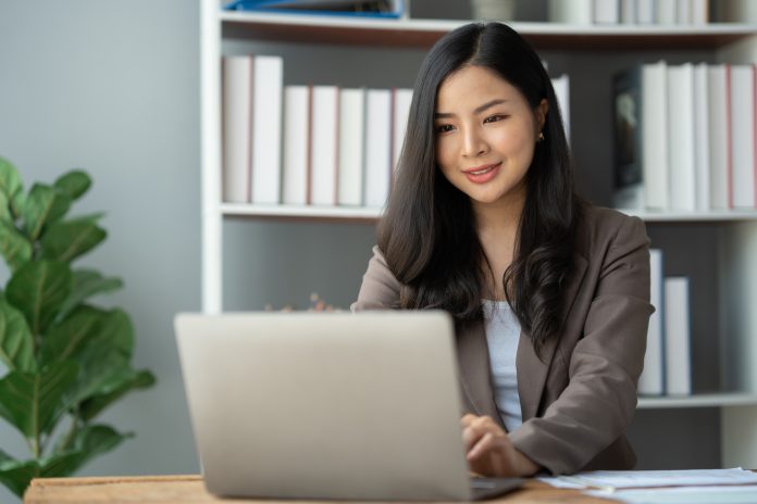 Asian businesswoman, self-employed working on laptop computer typing e-commerce marketing financial