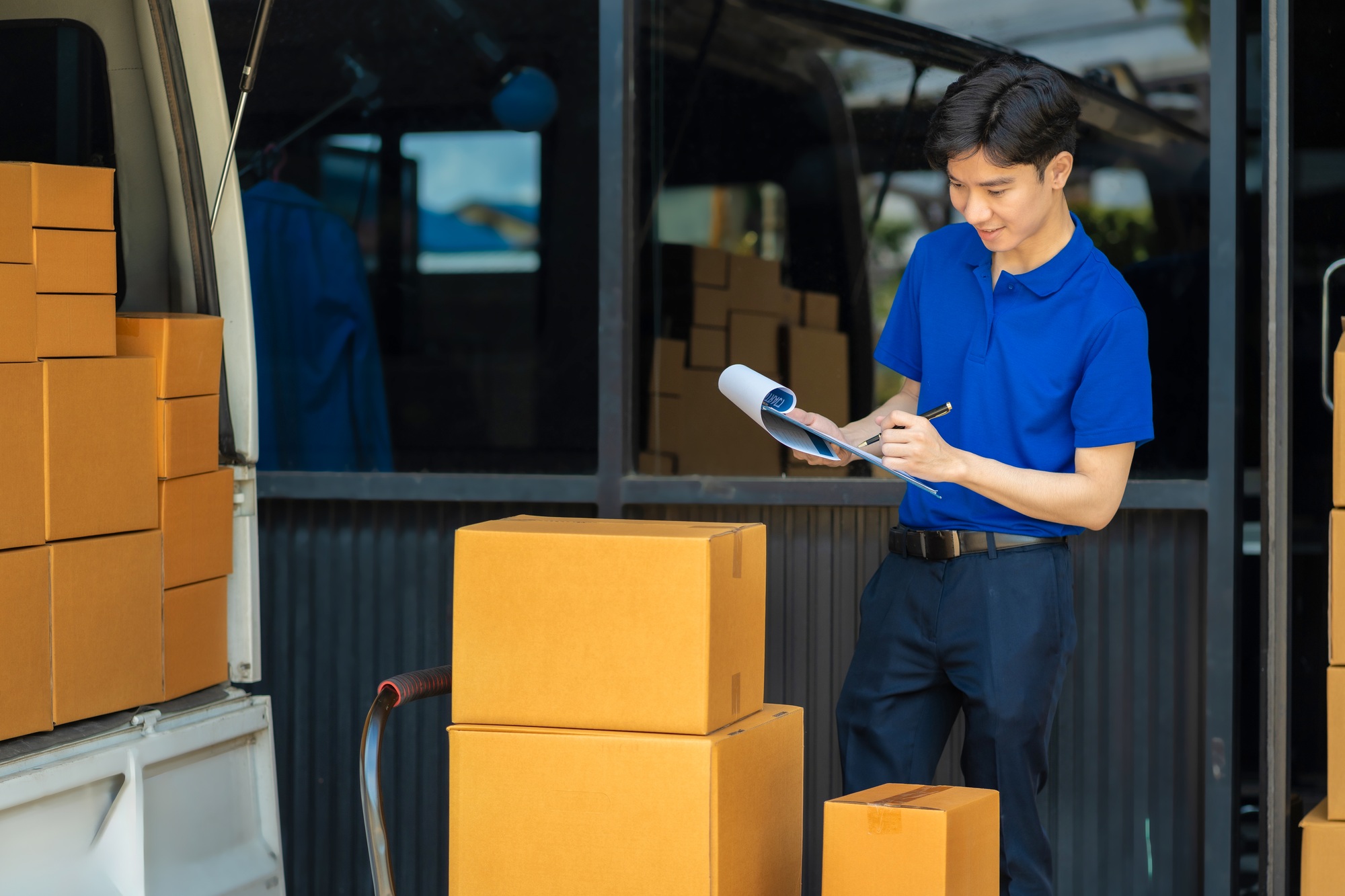 Asian delivery man work in truck for checking the product in the truck, concept ecommerce.