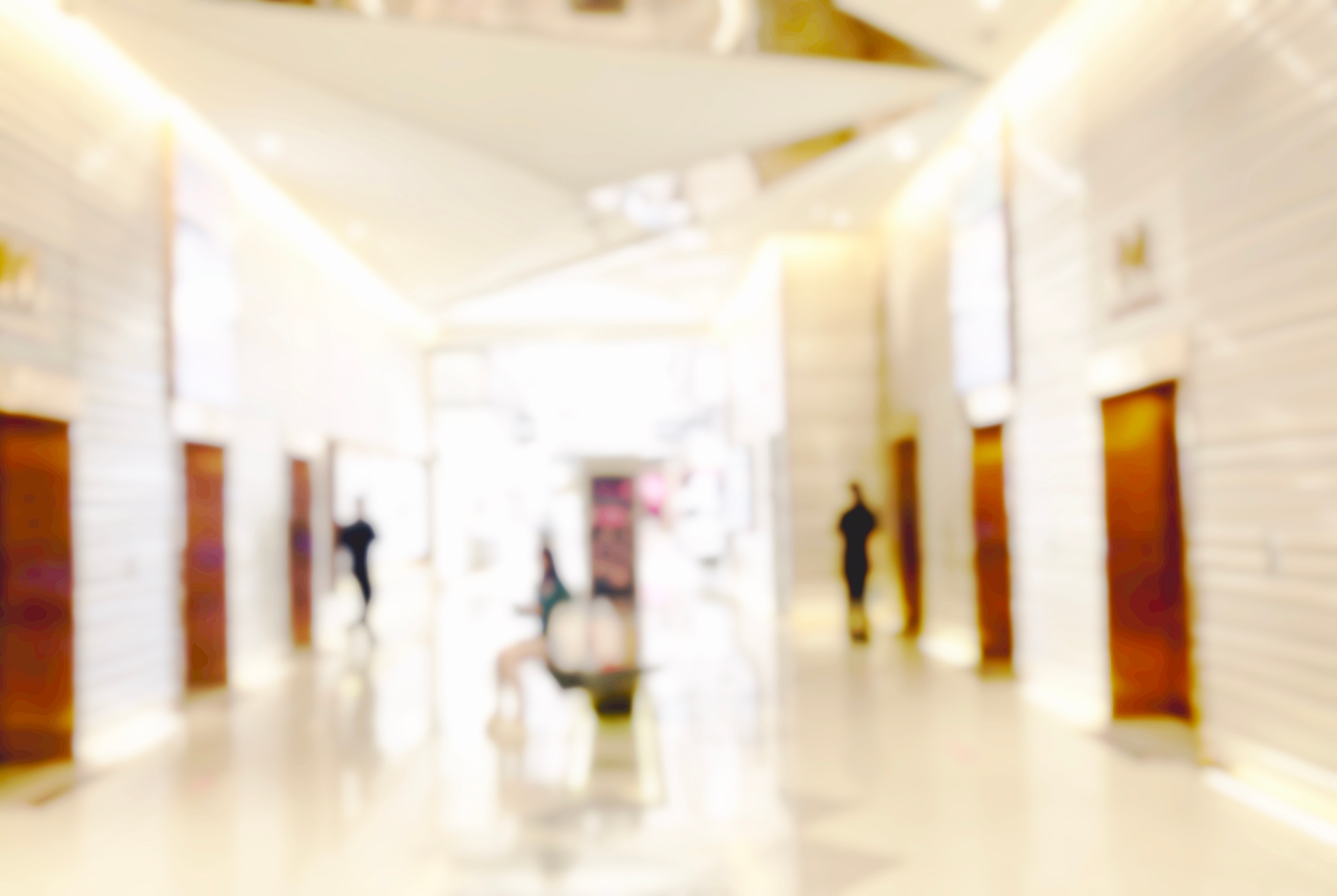 Blur light background at shop in mall for business background, blurry abstract bokeh at interior