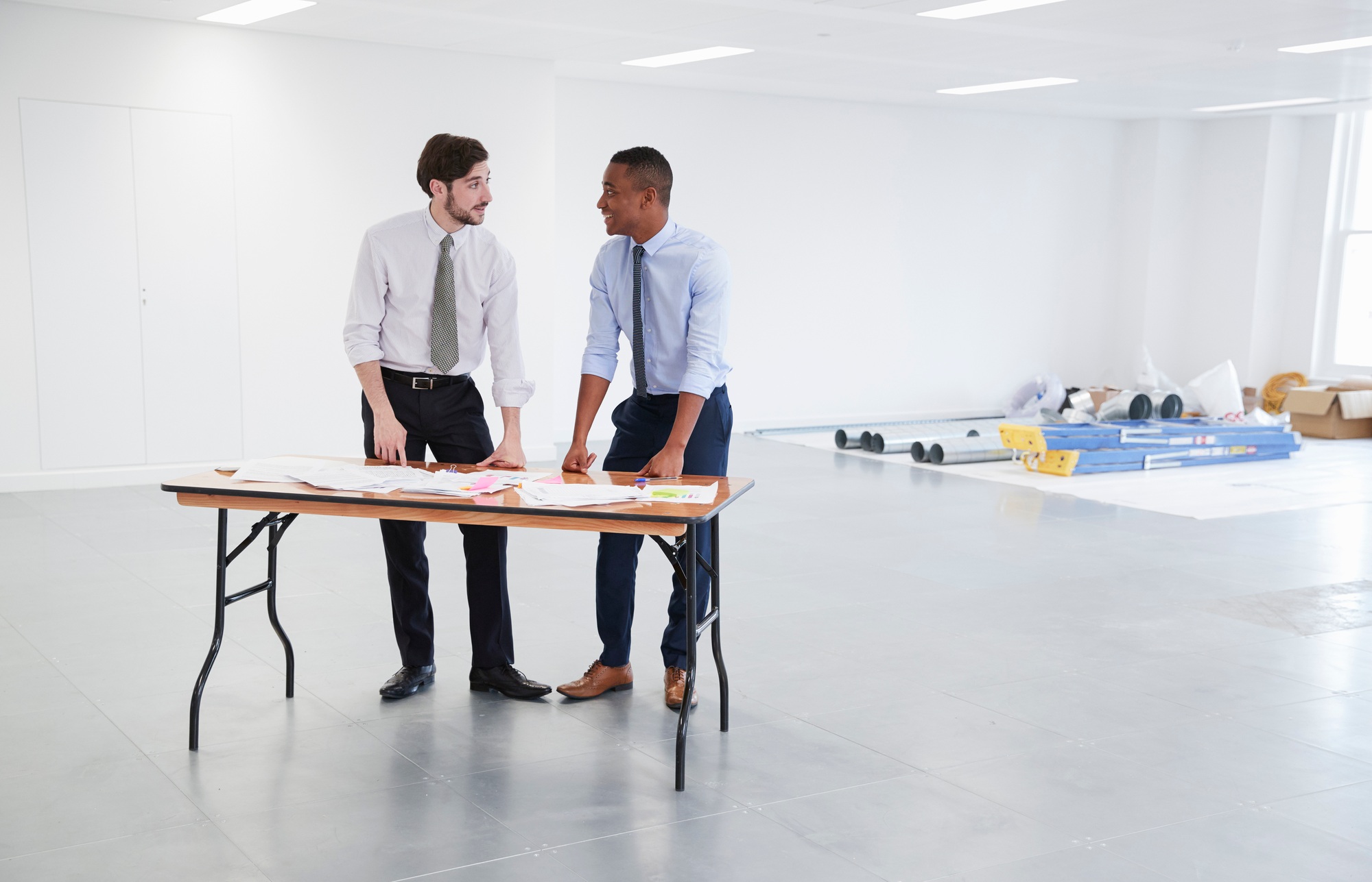 Businessmen discussing plans for office interior design