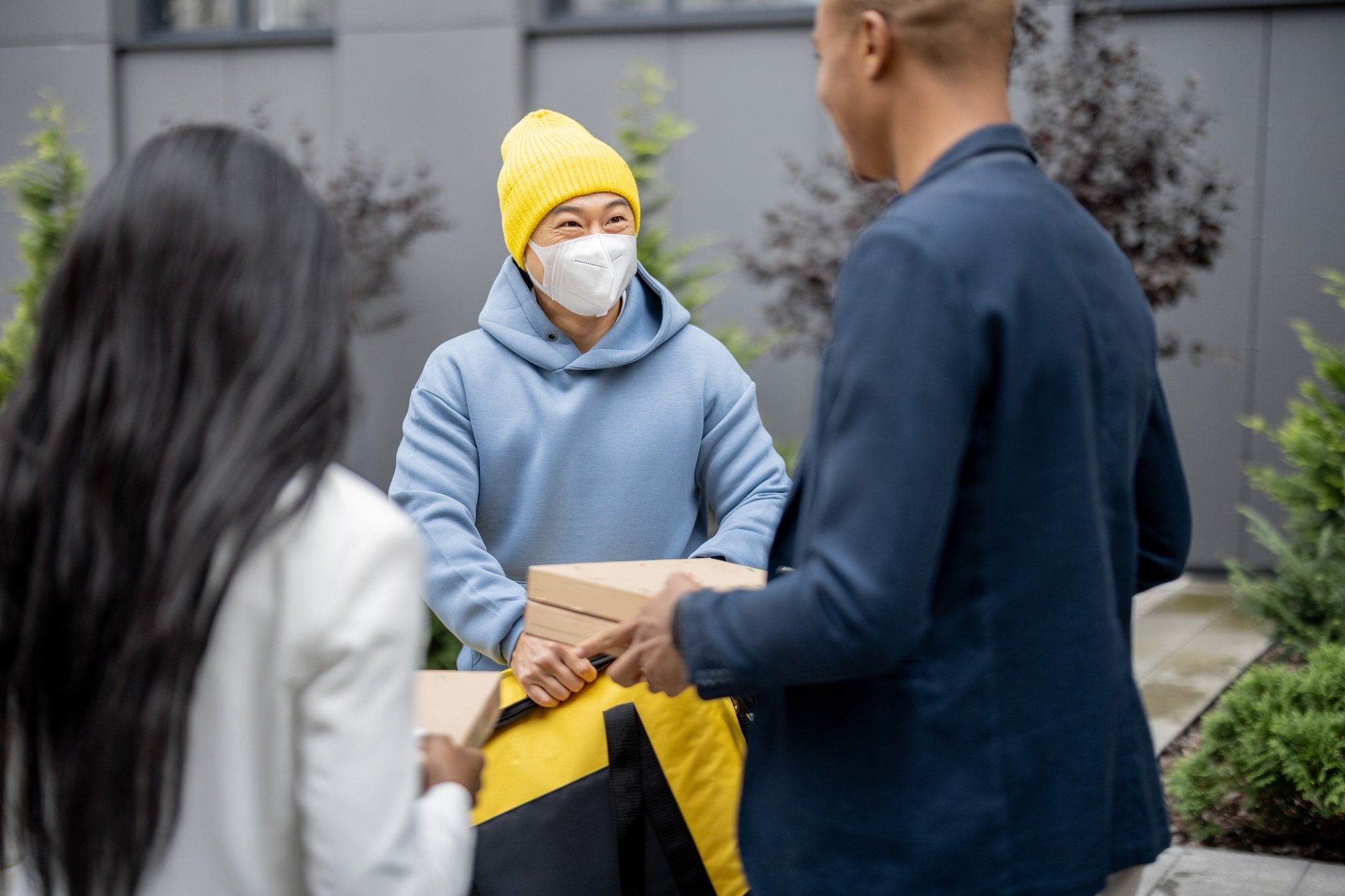 Businesspeople taking order from courier in city