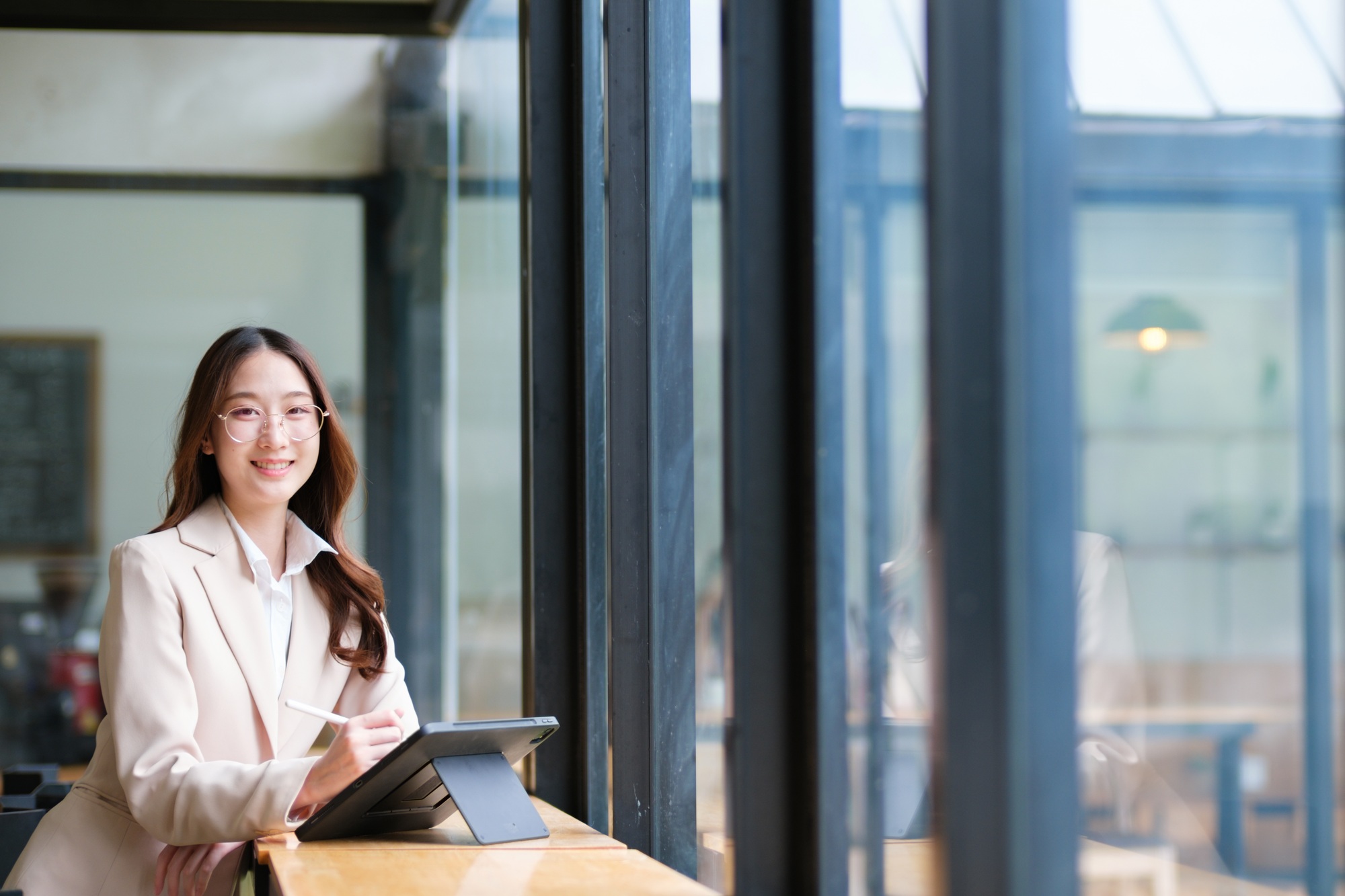 Businesswoman using a tablet and digital pen for online work and data analysis