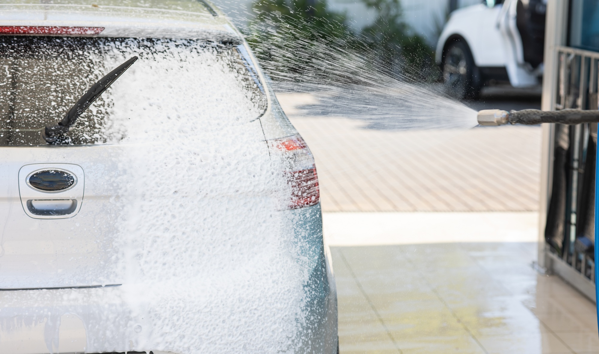 Car cleaning with foam shampoo at a car wash