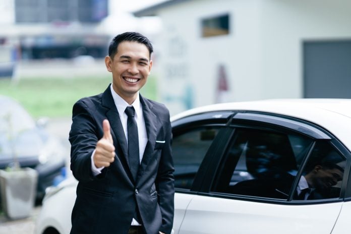 Car dealer man. Auto dealership and rental concept.