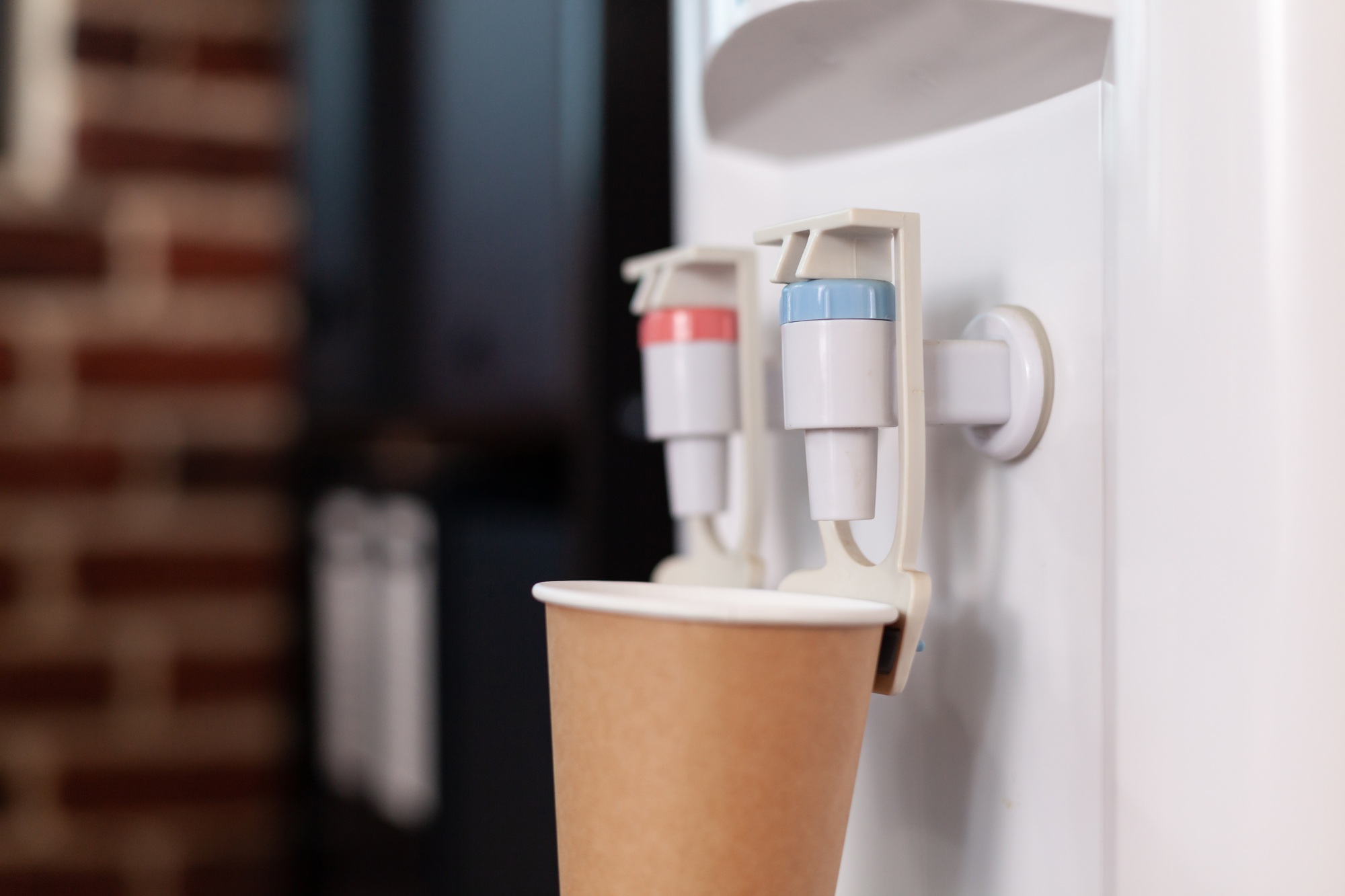 Close up of water dispenser and disposable cup