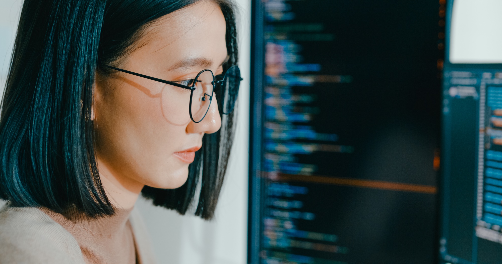 Closeup young adult Asia female freelance eyeglasses typing write prompt AI bot IT app program.