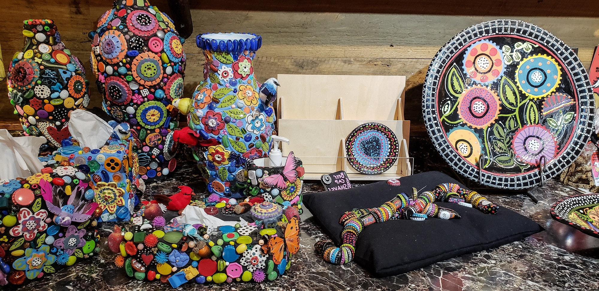 Colorful handmade pottery and dishes as works of cultural artwork for retail sale.