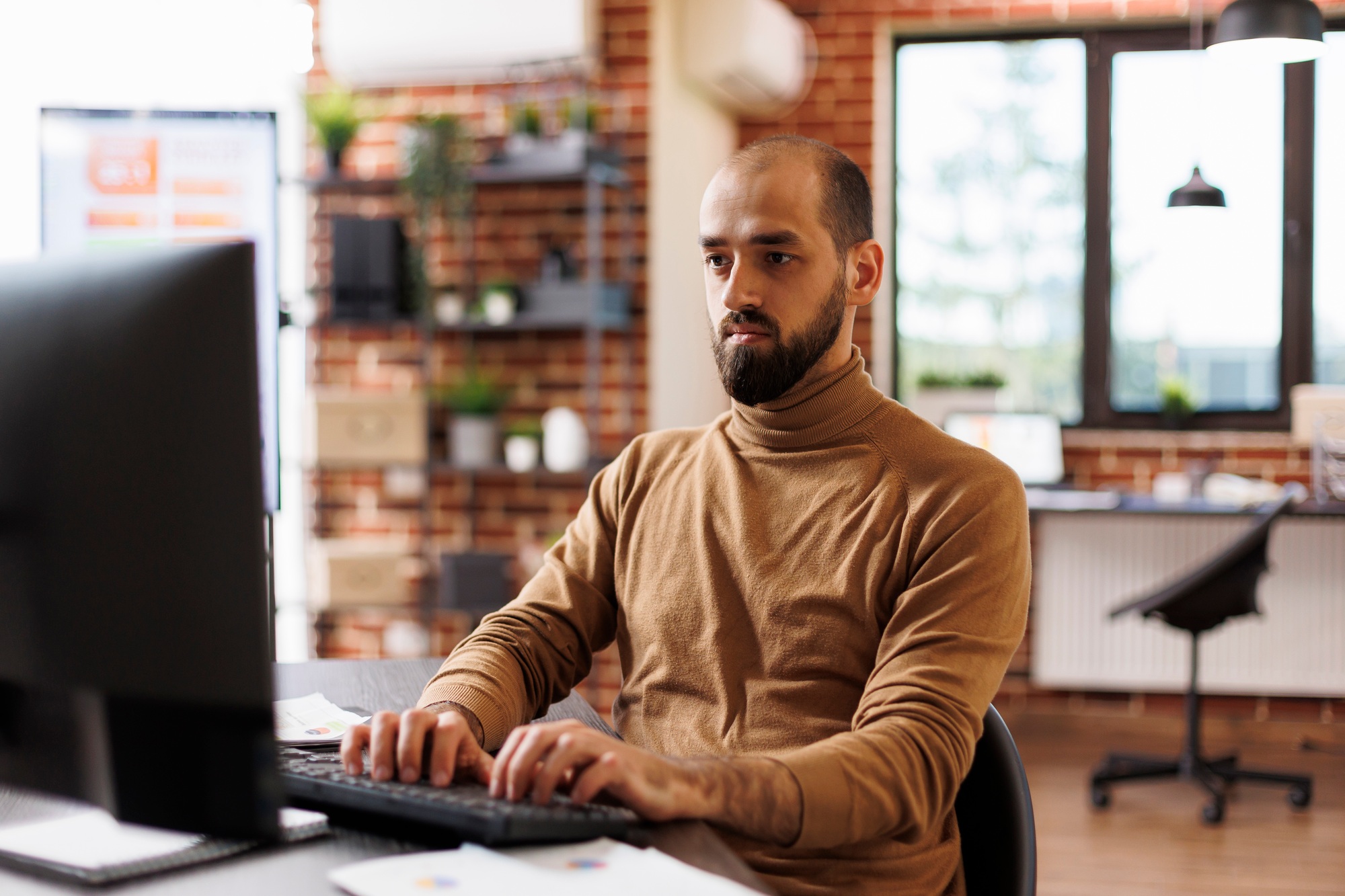 Confident project manager working on business strategy and financial analysis while sitting company