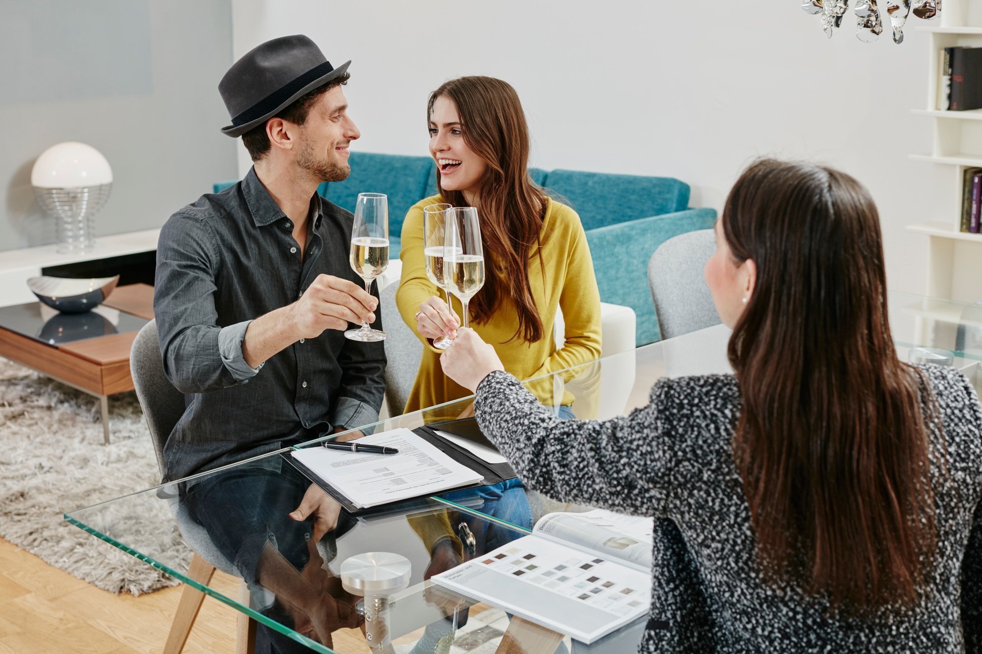 Couple celebrating sales contract in furniture store