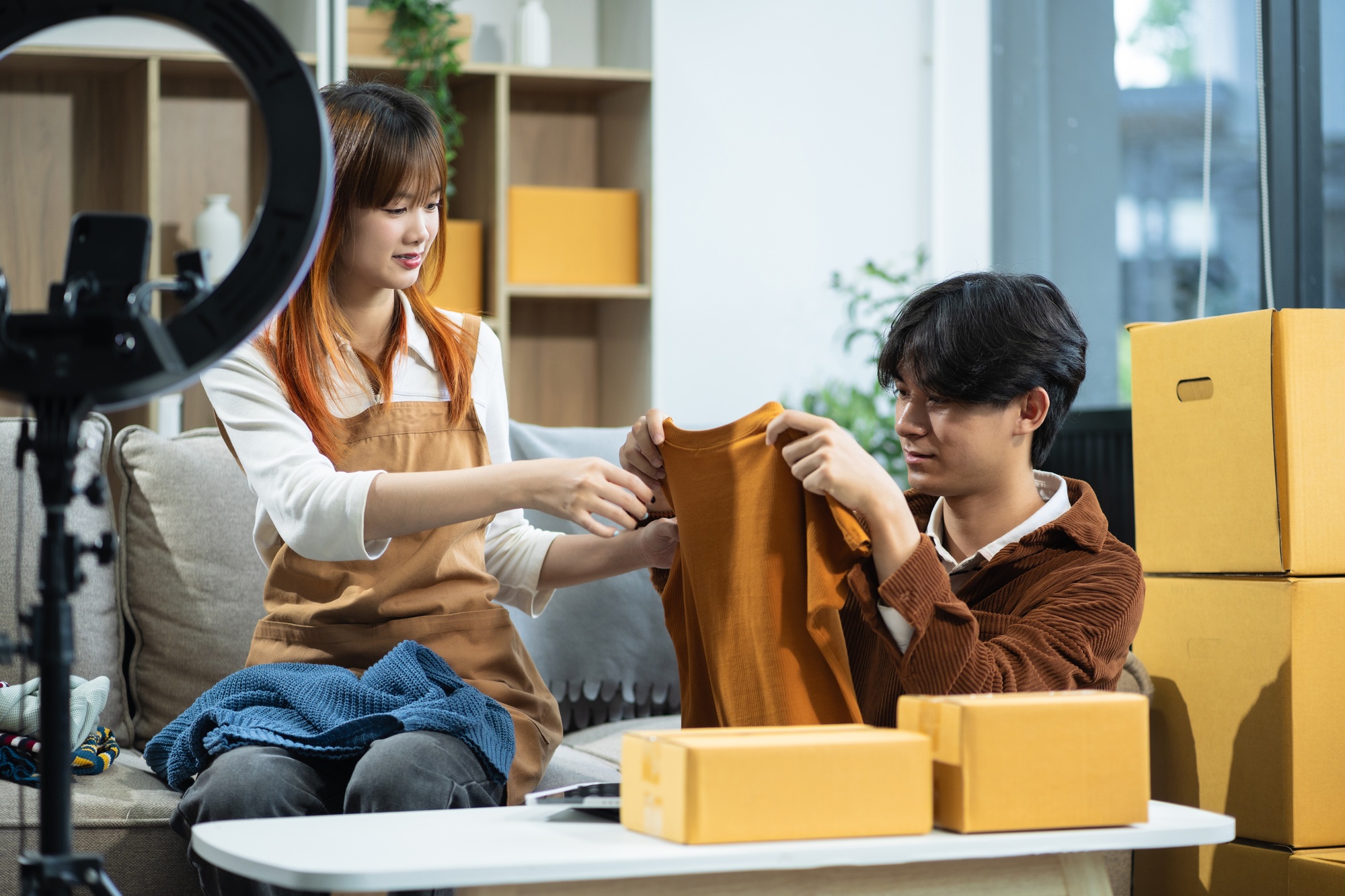 Couple start up small business owner. Couple sell clothes product online live streaming at home.