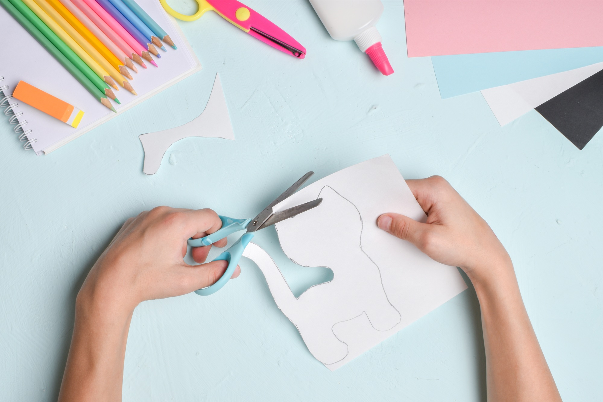 Crafts with children's hands made of colored paper. Handmade. The white tiger. Cat.