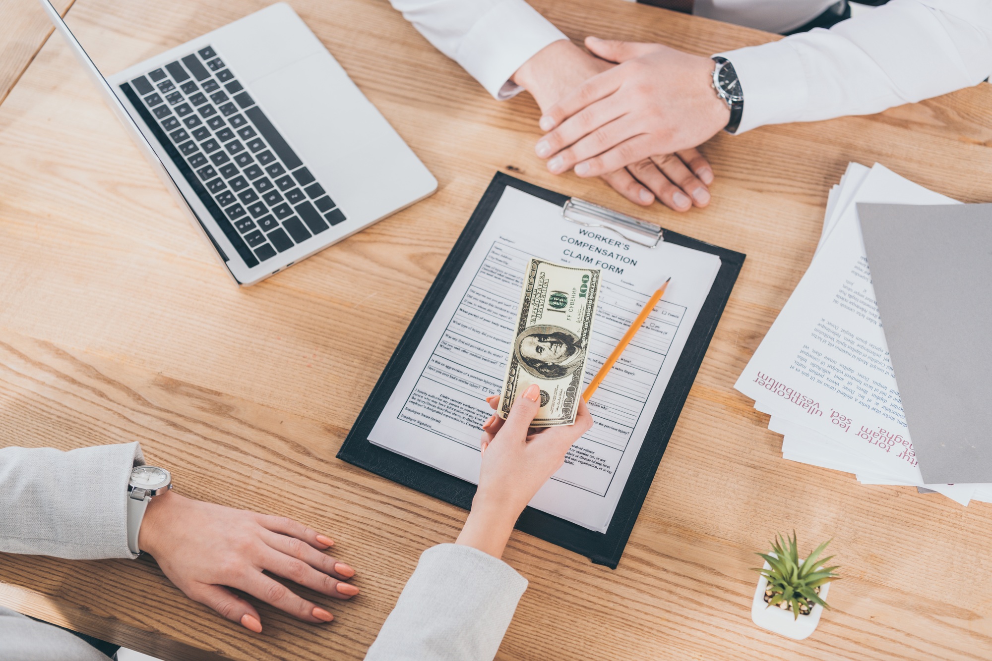 cropped view of businesswoman giving money to worker, compensation concept