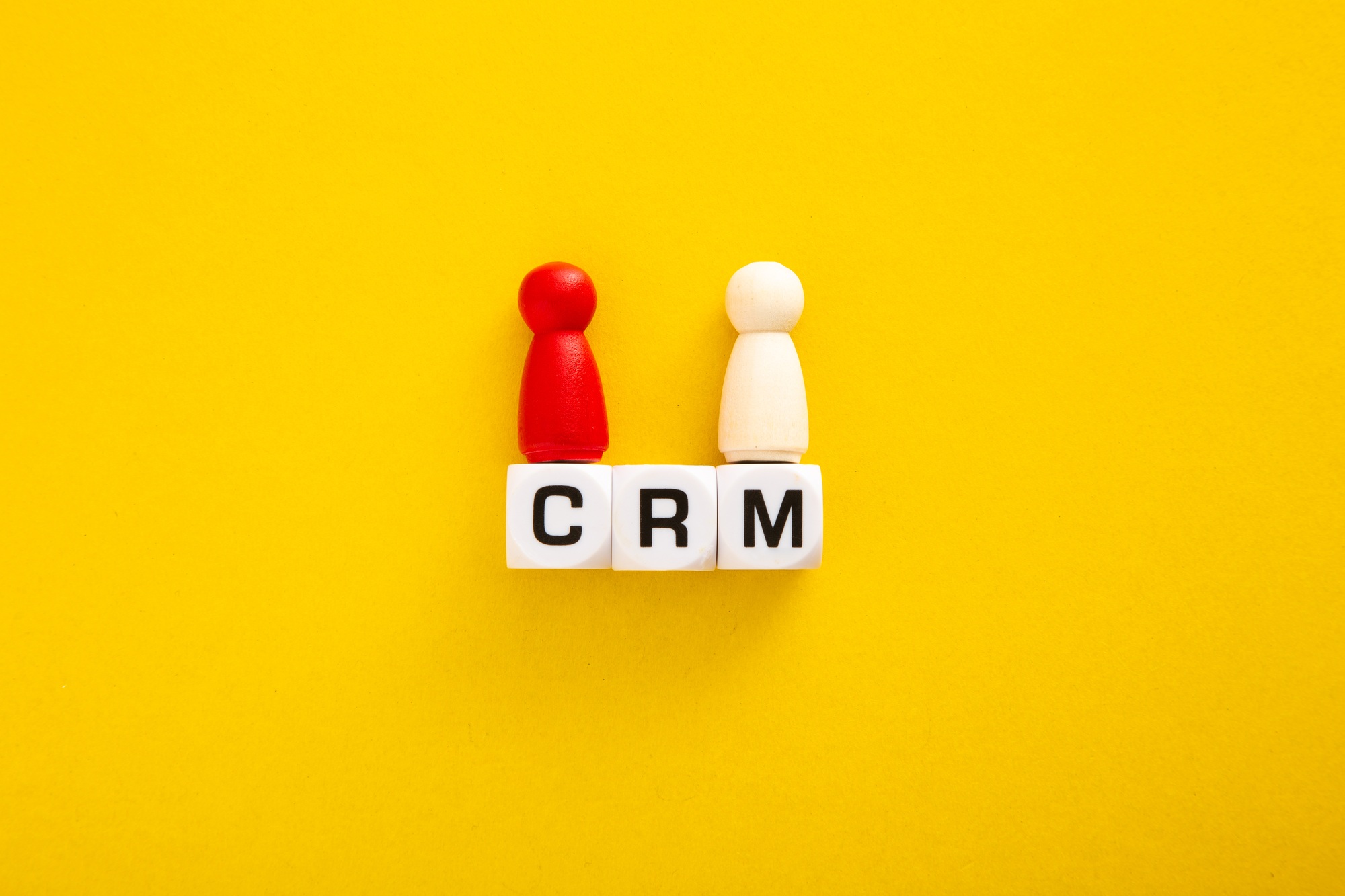 Customer relationship management concept with crm block letters and figurines