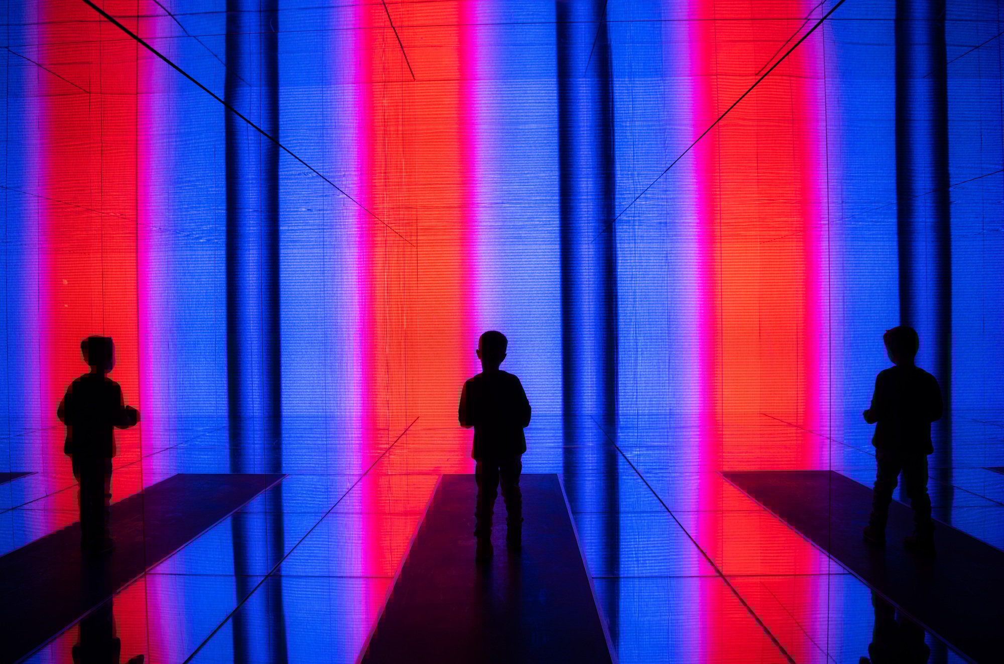 Data visualization. A boy stands in front of a huge light screen