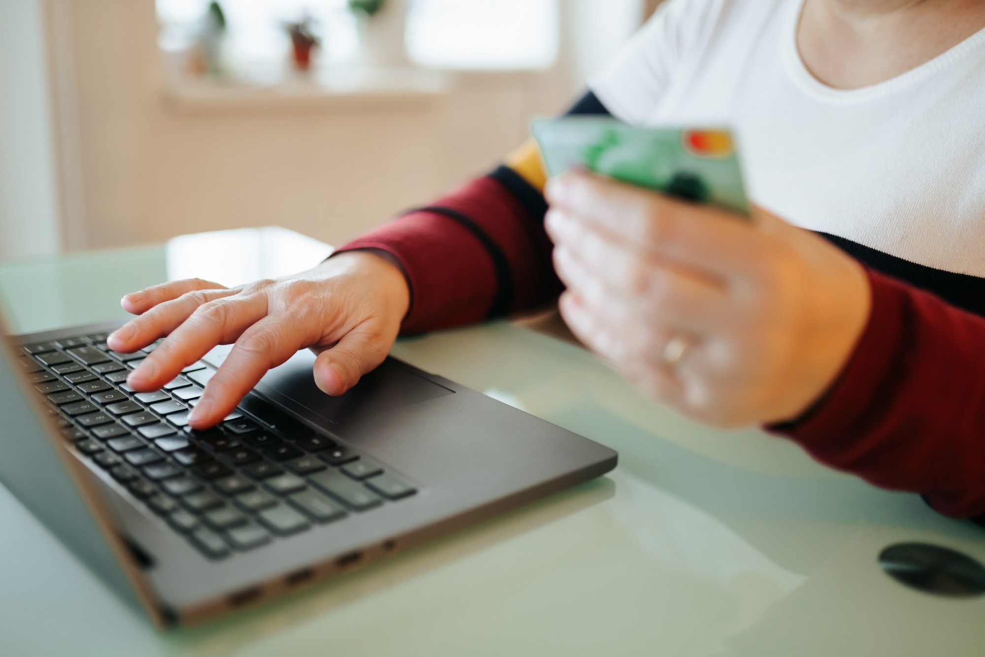 Engaging in online shopping from home with a laptop and credit card