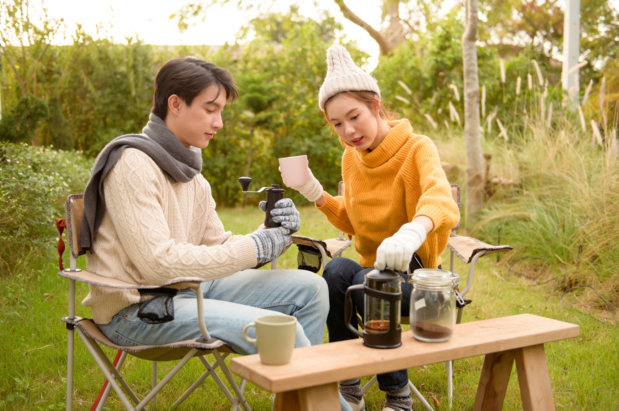 Enjoying Warm Drinks and Conversation in a Sunny Outdoor Garden During Autumn Afternoon