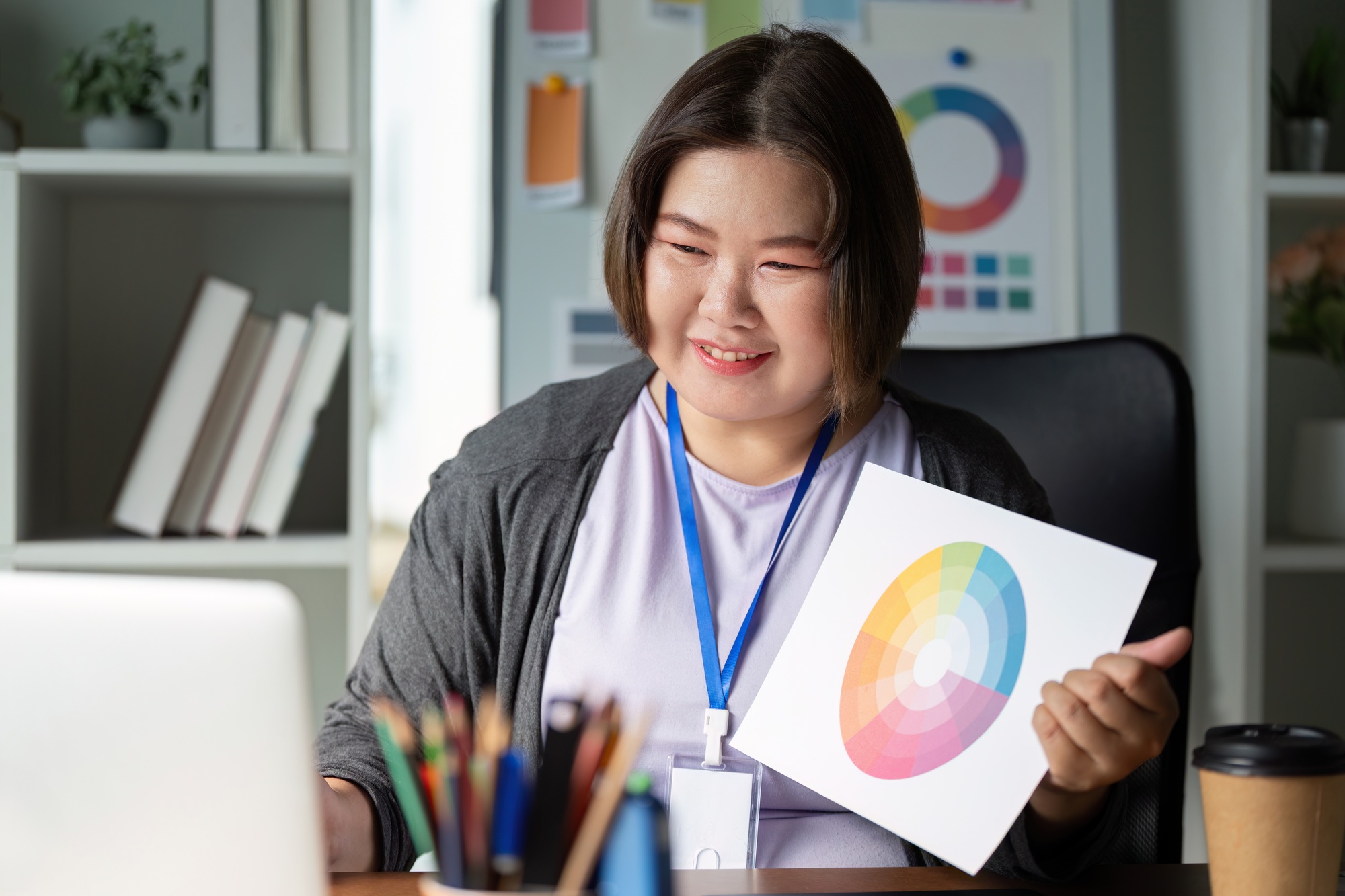 Enthusiastic graphic designer showcasing a color wheel and discussing designs