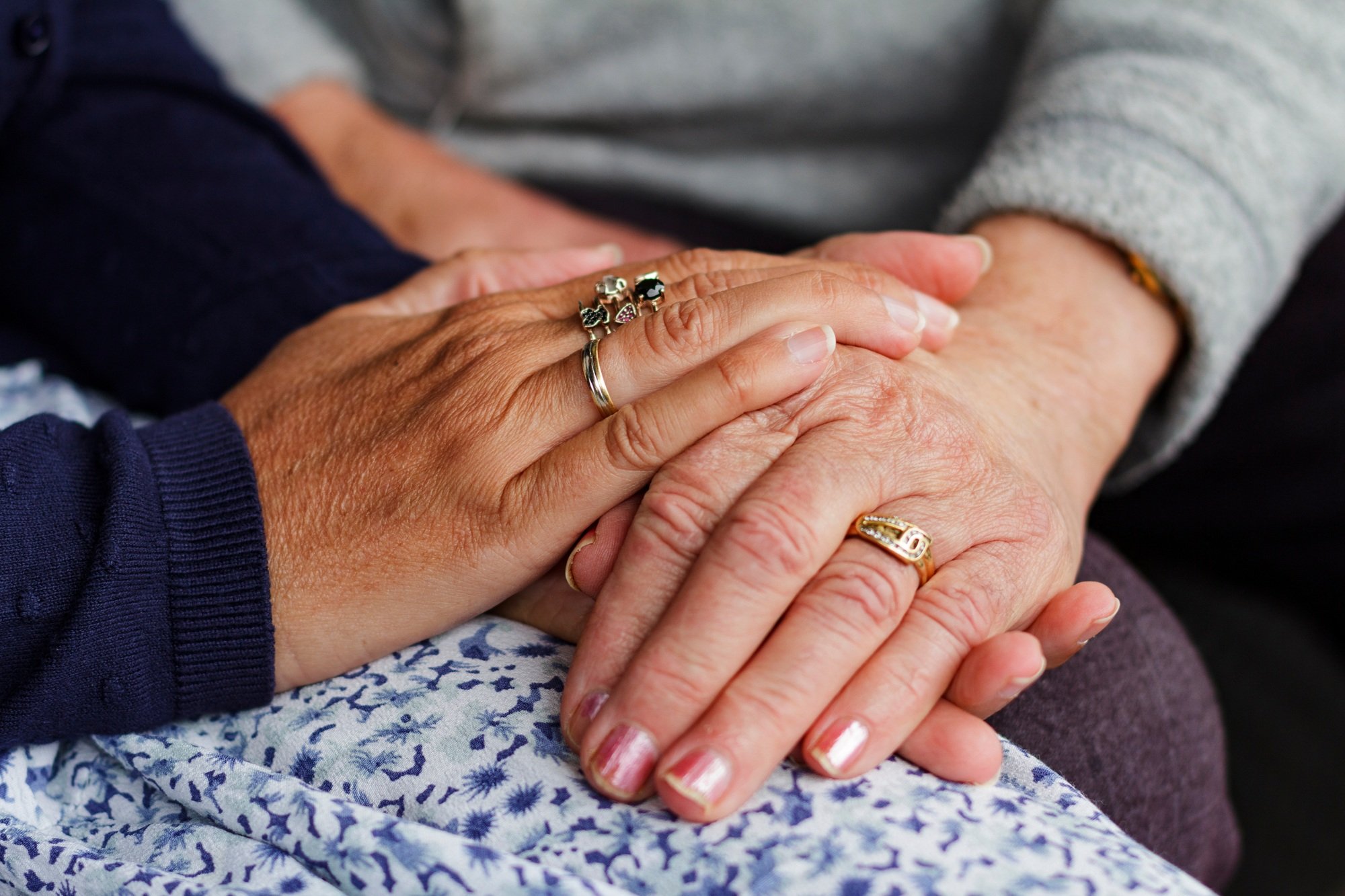 Female hands holding her mother hands, two women holding her hands, mother, daughter, support