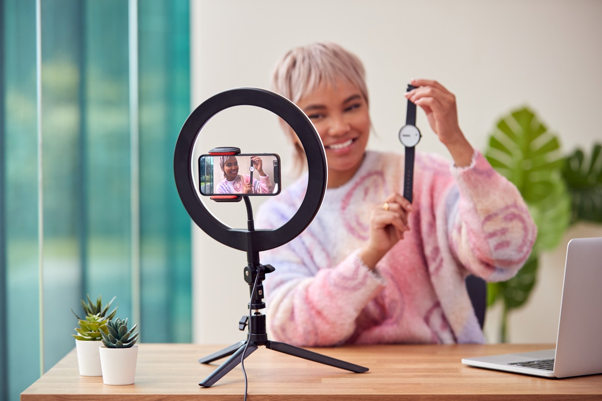 Female Vlogger Recording Wristwatch Product Review Video At Home With Mobile Phone