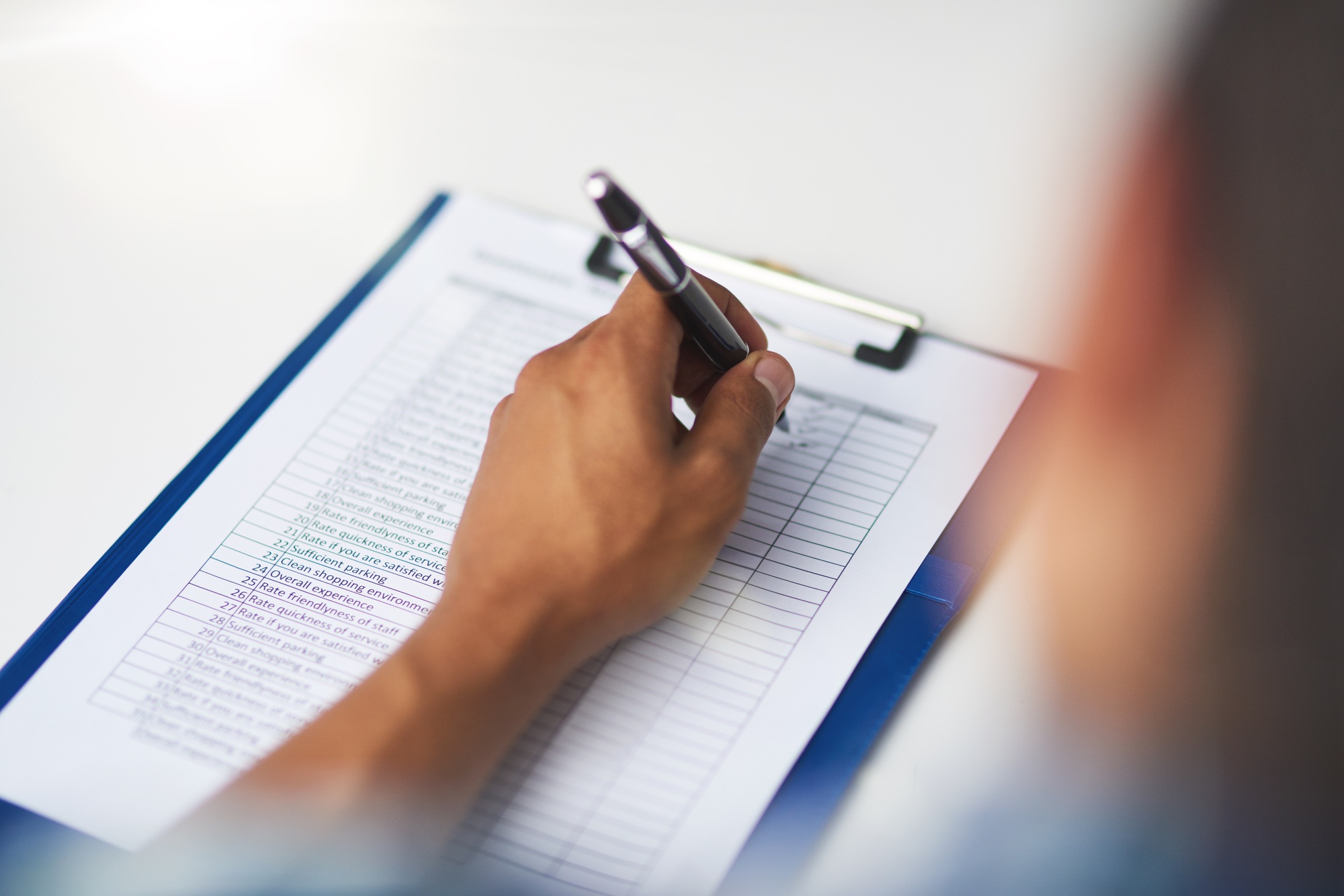 Filing out a survey. Shot of a person filling in a form.
