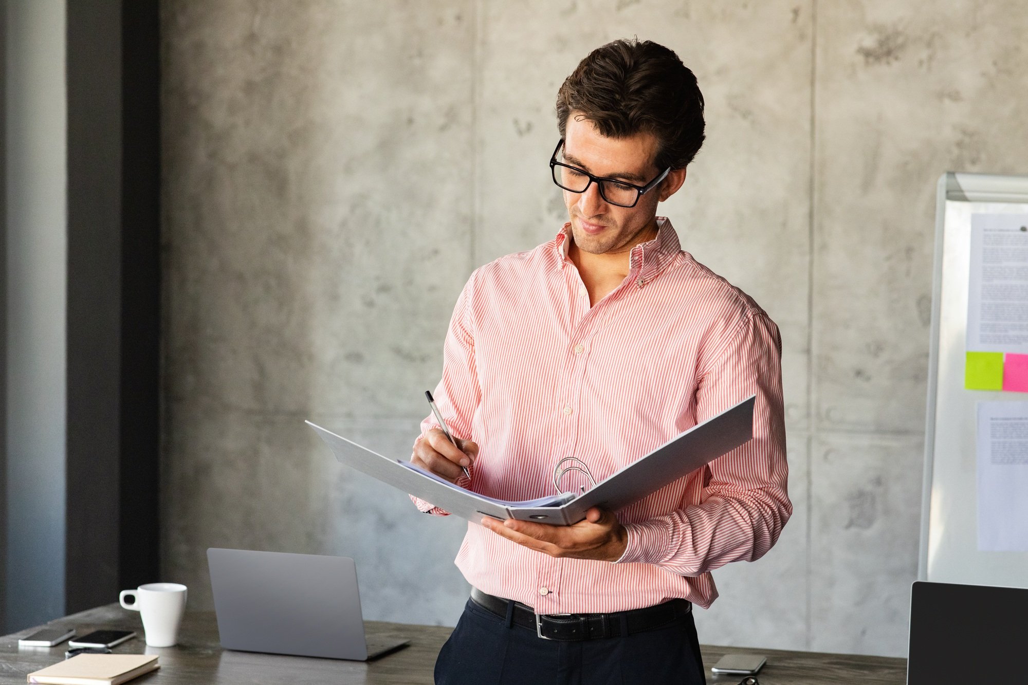 Financial director checking marketing report, office interior