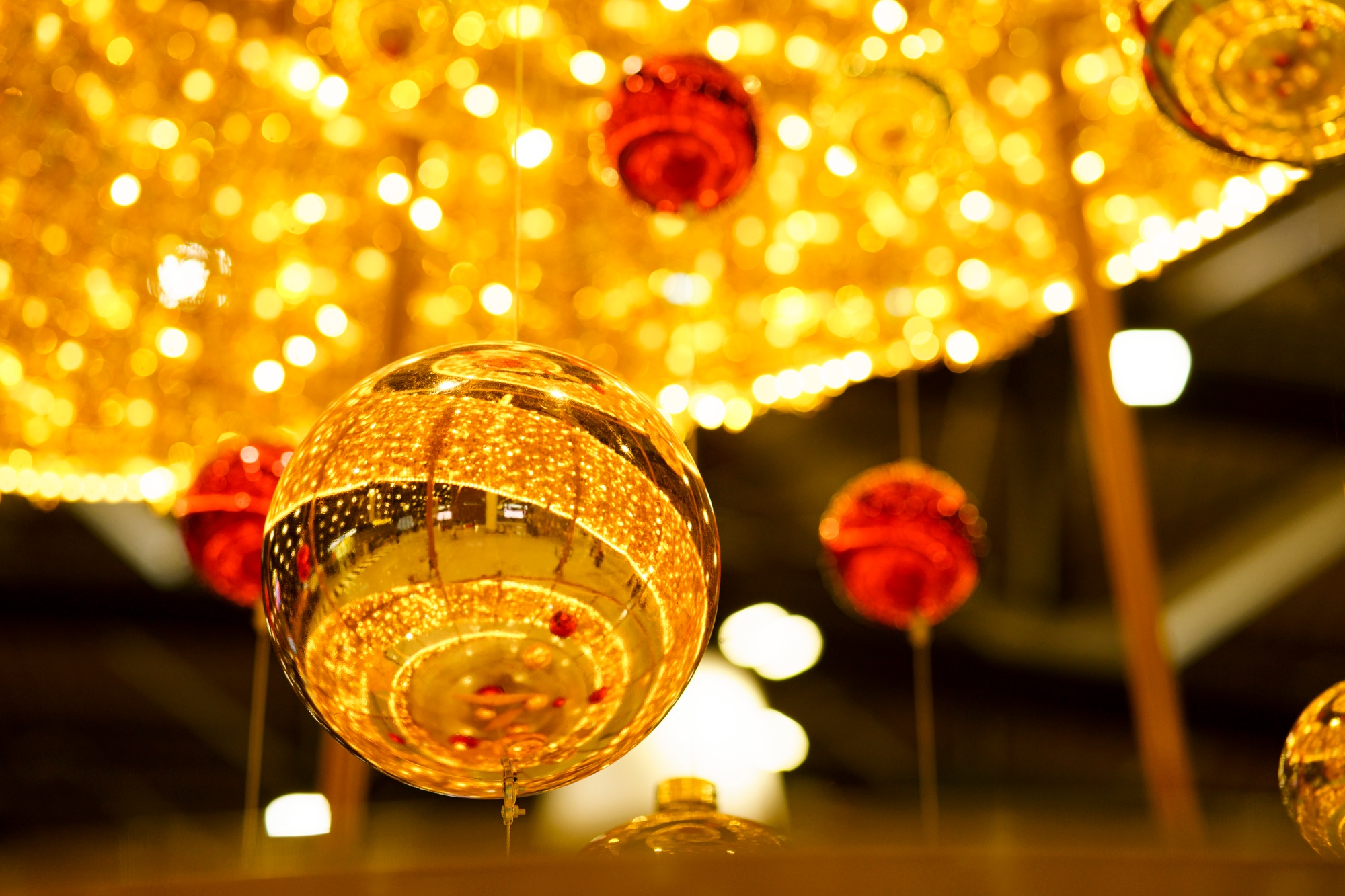 Gold, red Christmas balls in interior of public space, mall