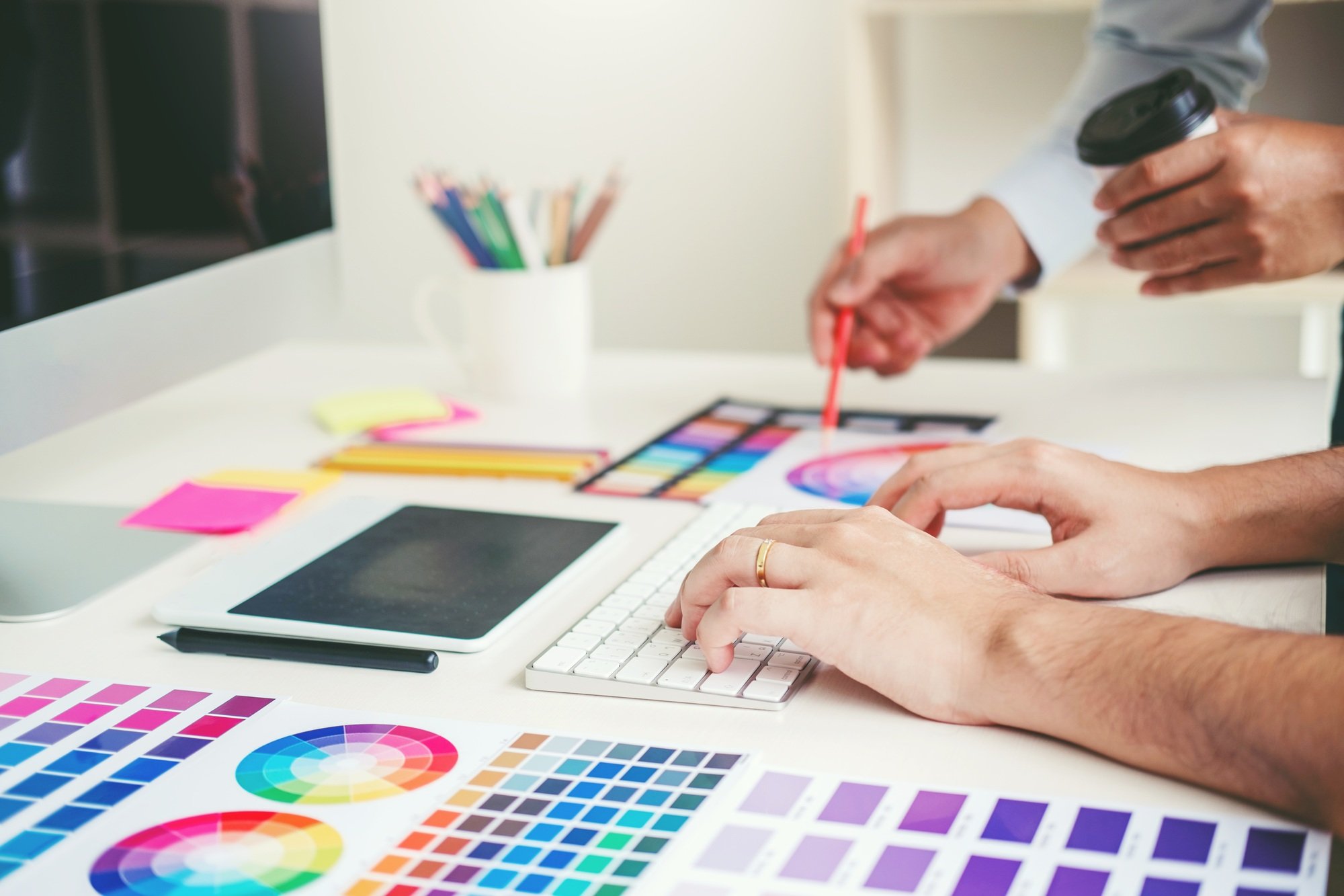 Graphic designer drawing on graphics tablet at workplace