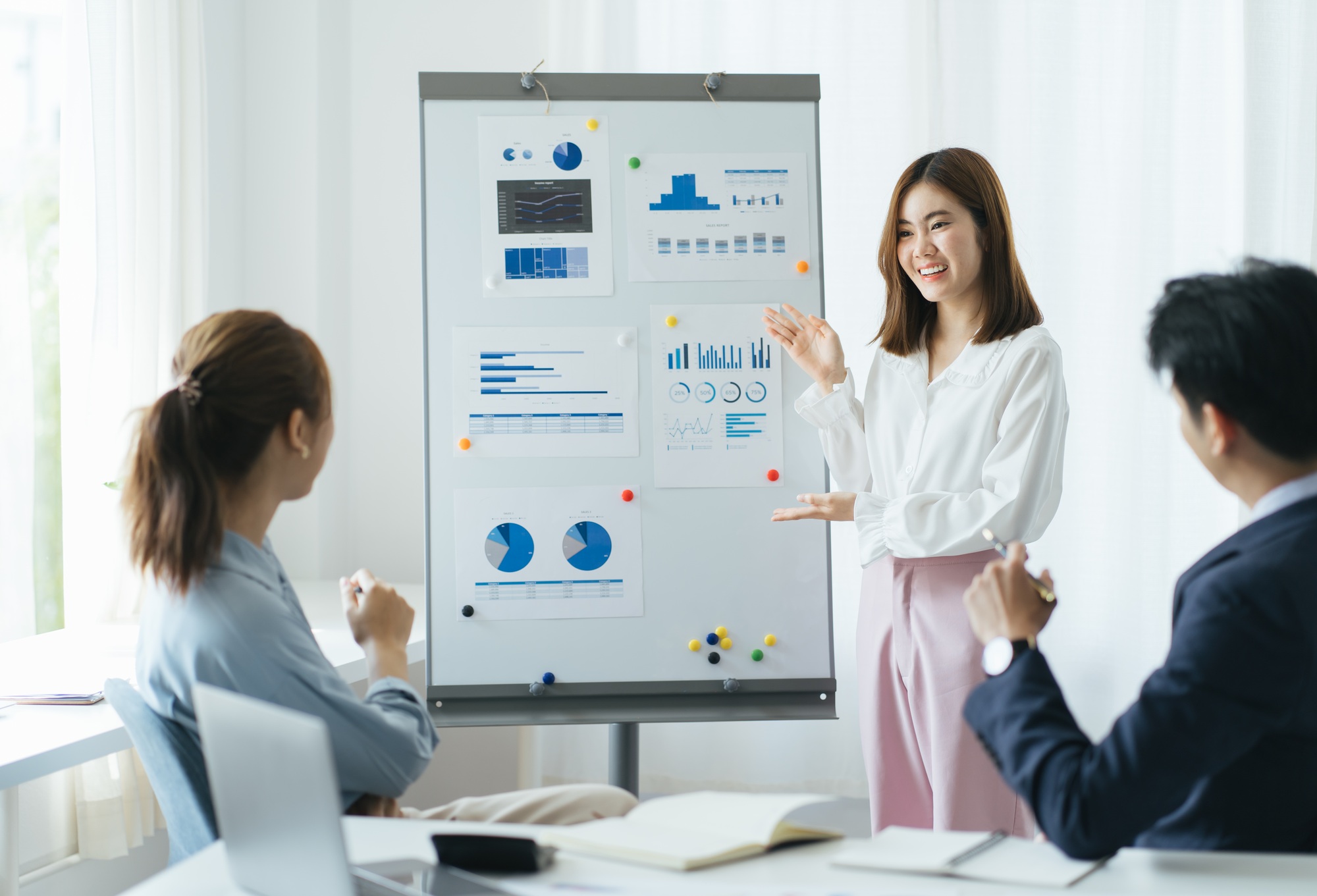 Group of mature businesspeople planning business strategy while looking at infographic on wall. Busi