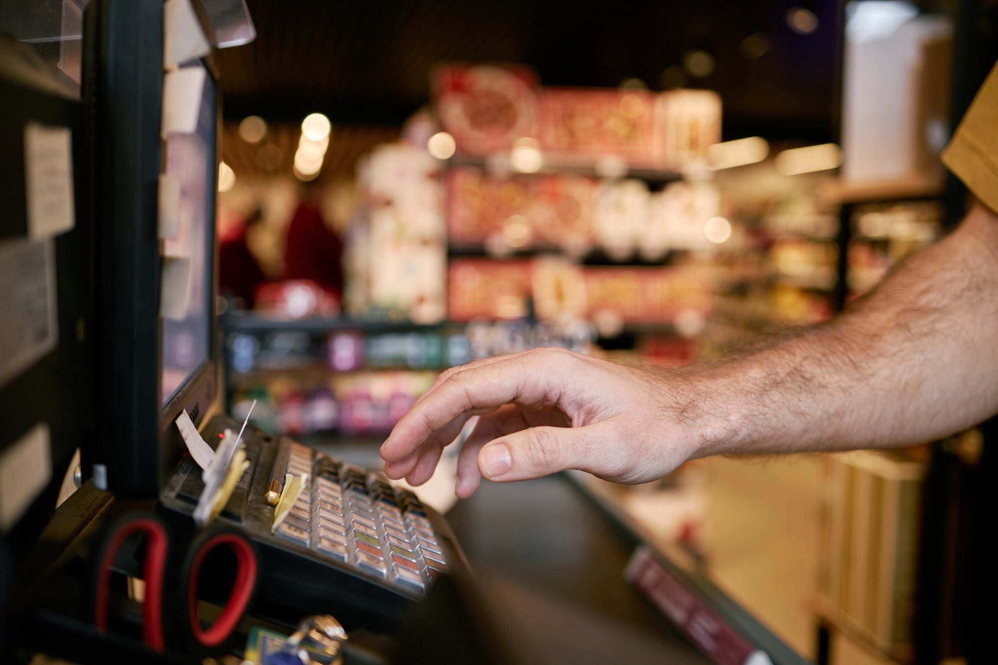 Hand Touching Vending Machine Screen in a Convenience Store