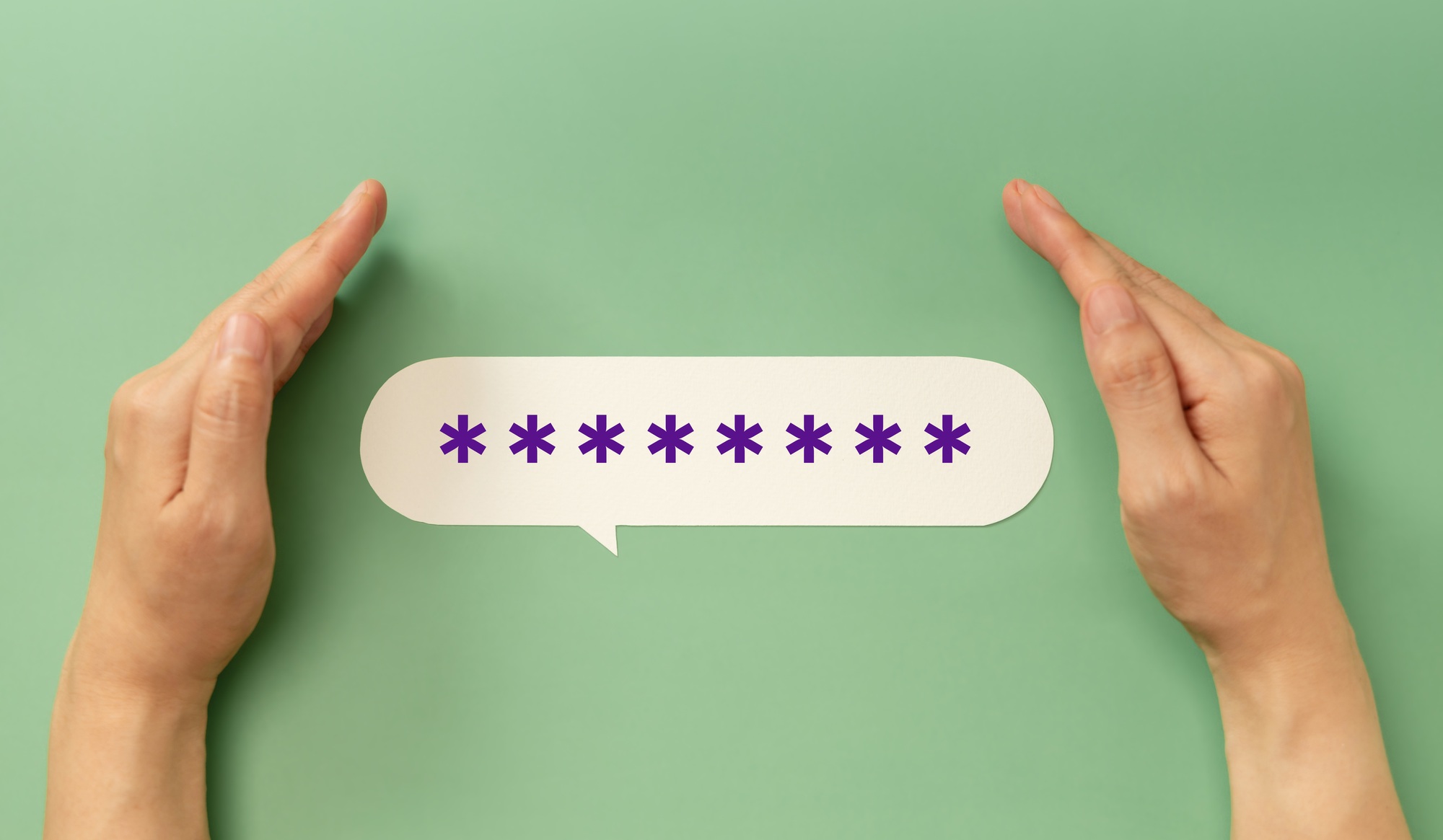 Hands protecting a hidden password speech bubble symbolizing online security