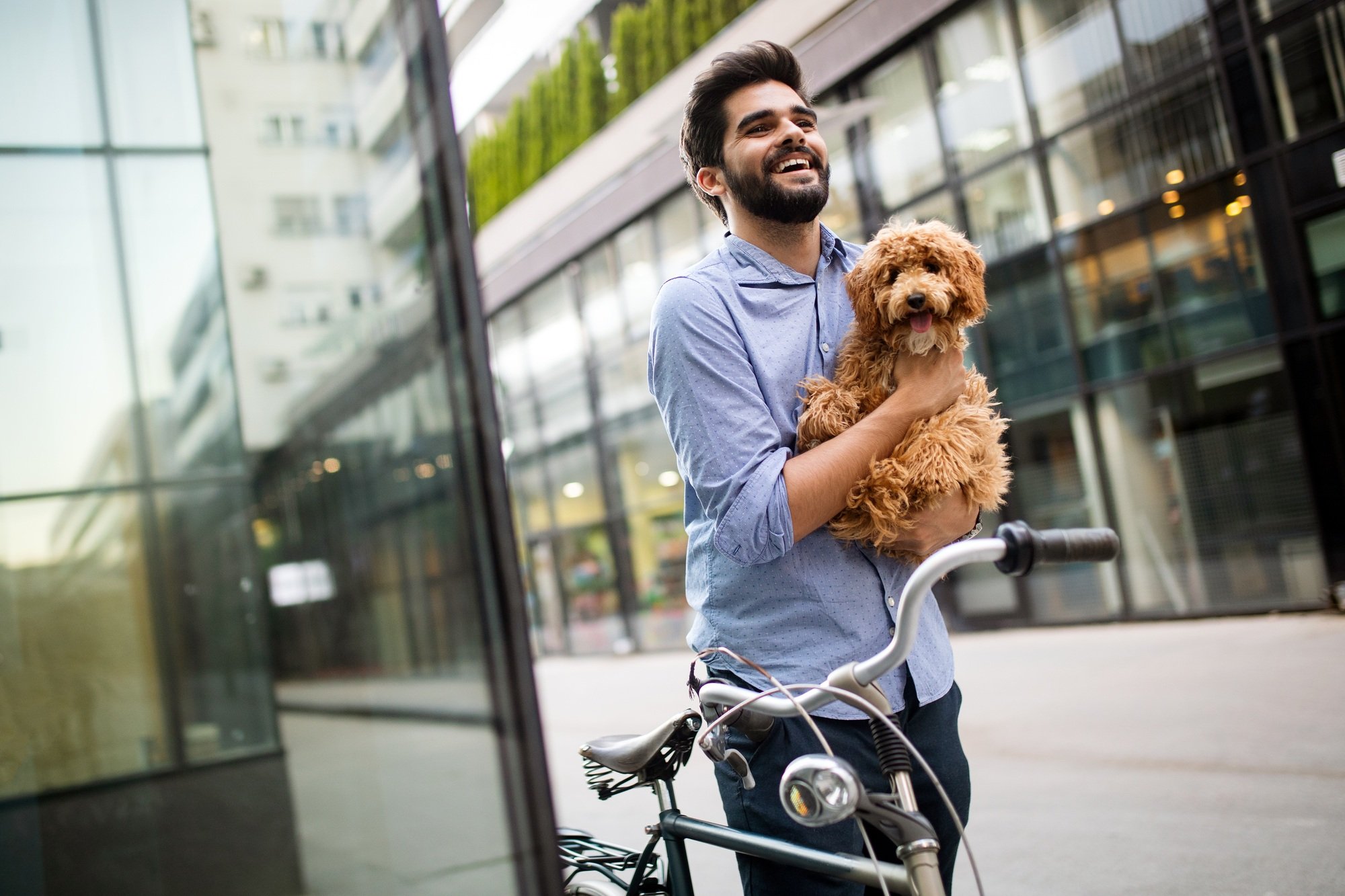 Handsome young businessman walking with his lovely dog