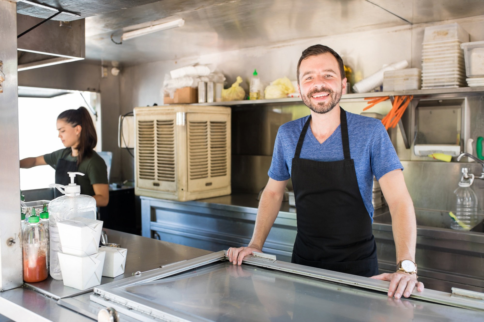 Happy worker in a food truck