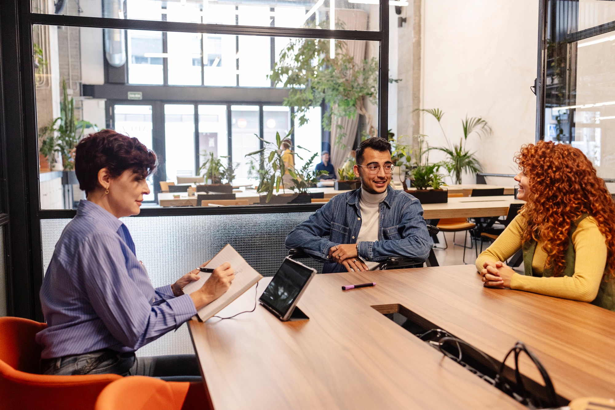 Human resources manager interviewing young candidates in modern office